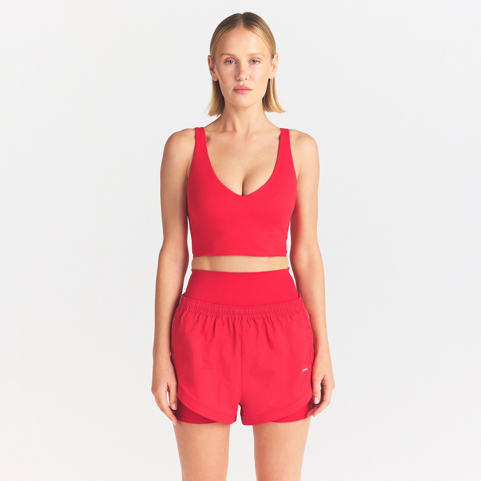 NikeSKIMS MATTE V-NECK BRA TOP | UNIVERSITY RED ON A MODEL SIDE VIEW @ | FOCUS: 0.0, 1.0, 0.9