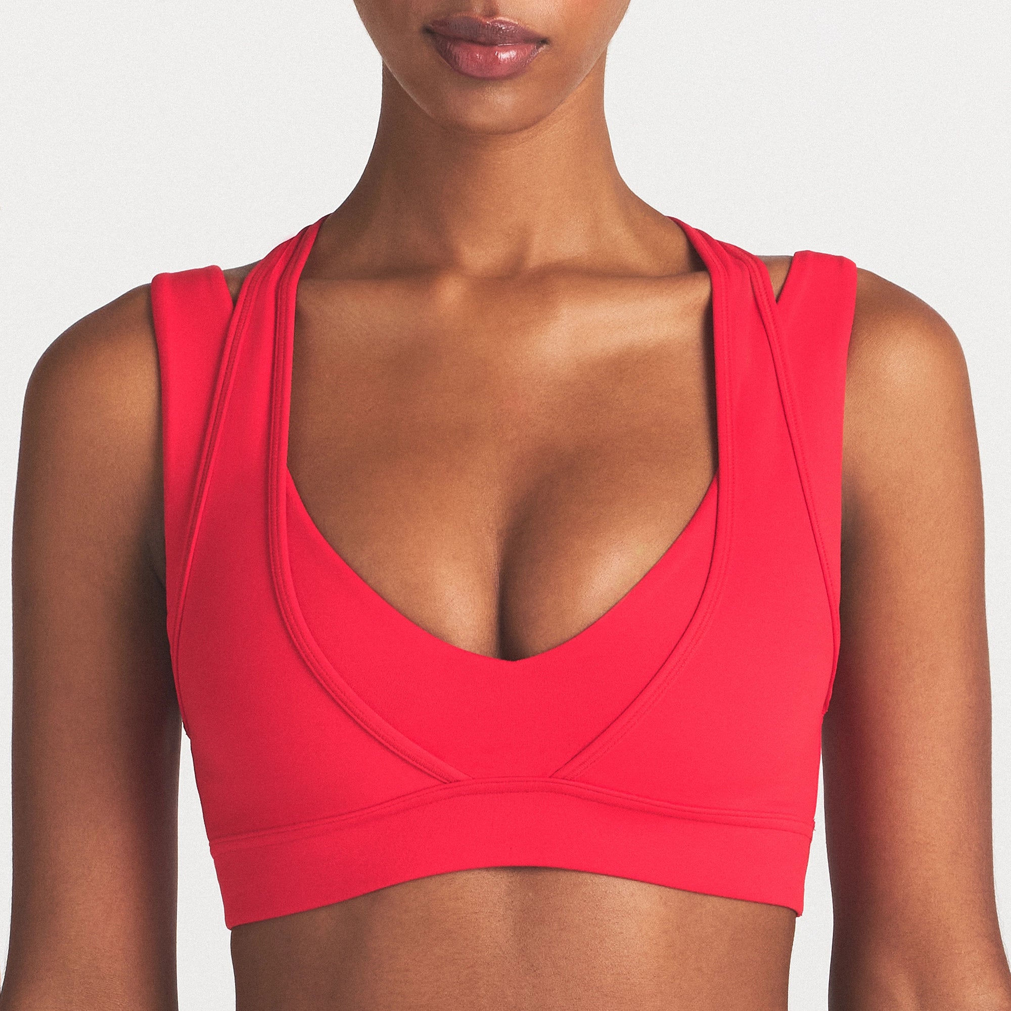NikeSKIMS MATTE PLUNGE DOUBLE LAYER BRA | UNIVERSITY RED ON A MODEL SIDE VIEW @ | FOCUS: 0.0, 1.0, 0.9