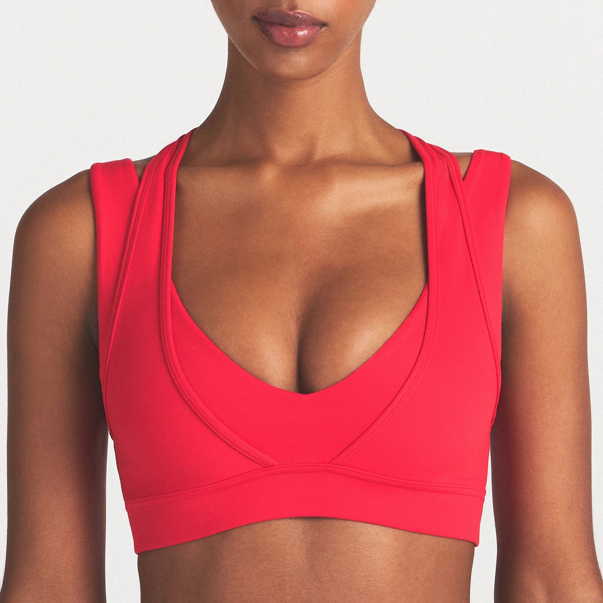 NikeSKIMS MATTE PLUNGE DOUBLE LAYER BRA | UNIVERSITY RED ON A MODEL SIDE VIEW @ | FOCUS: 0.0, 1.0, 0.9