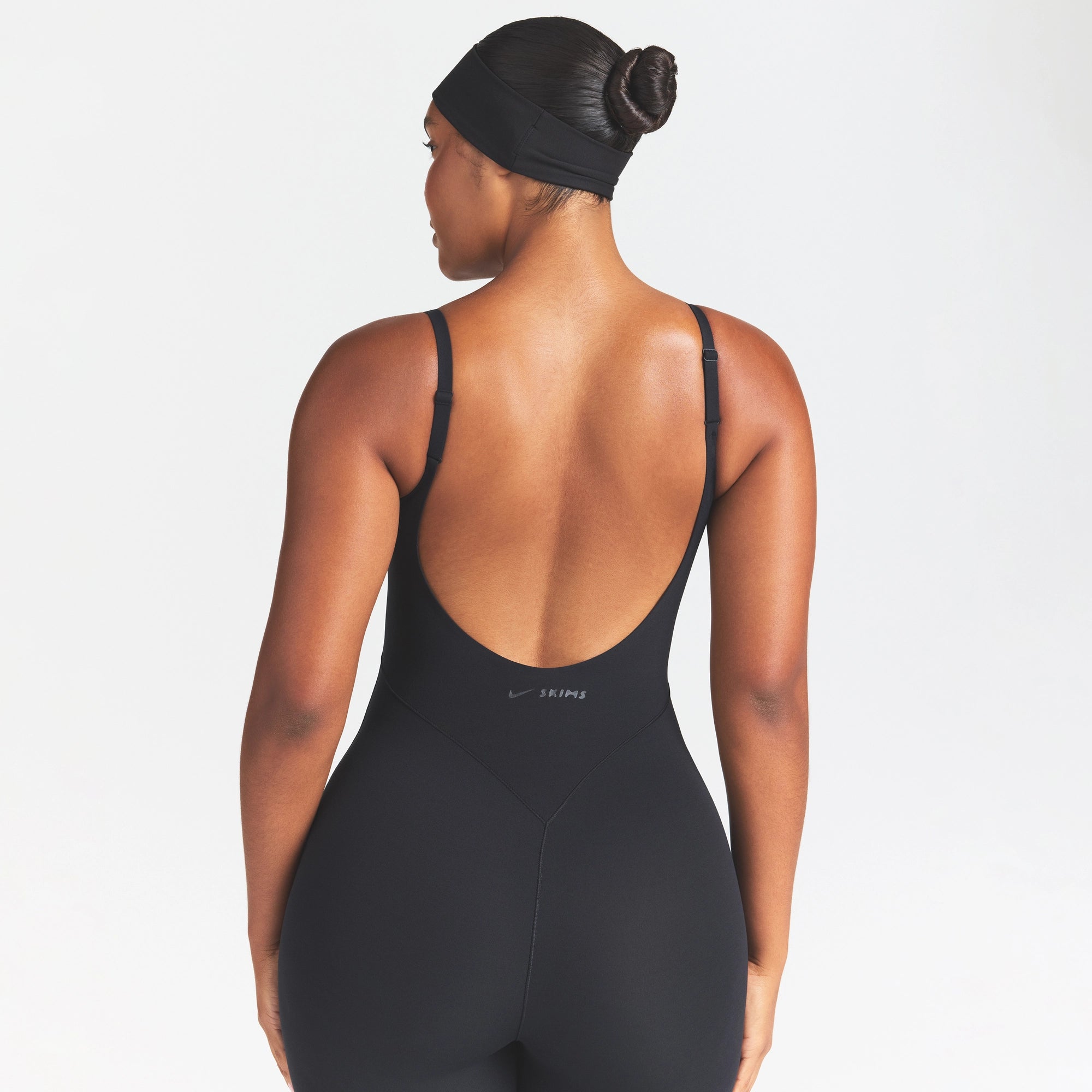 NikeSKIMS STUDIO STRETCH 29" ONE PIECE | OBSIDIAN ON A MODEL SIDE VIEW