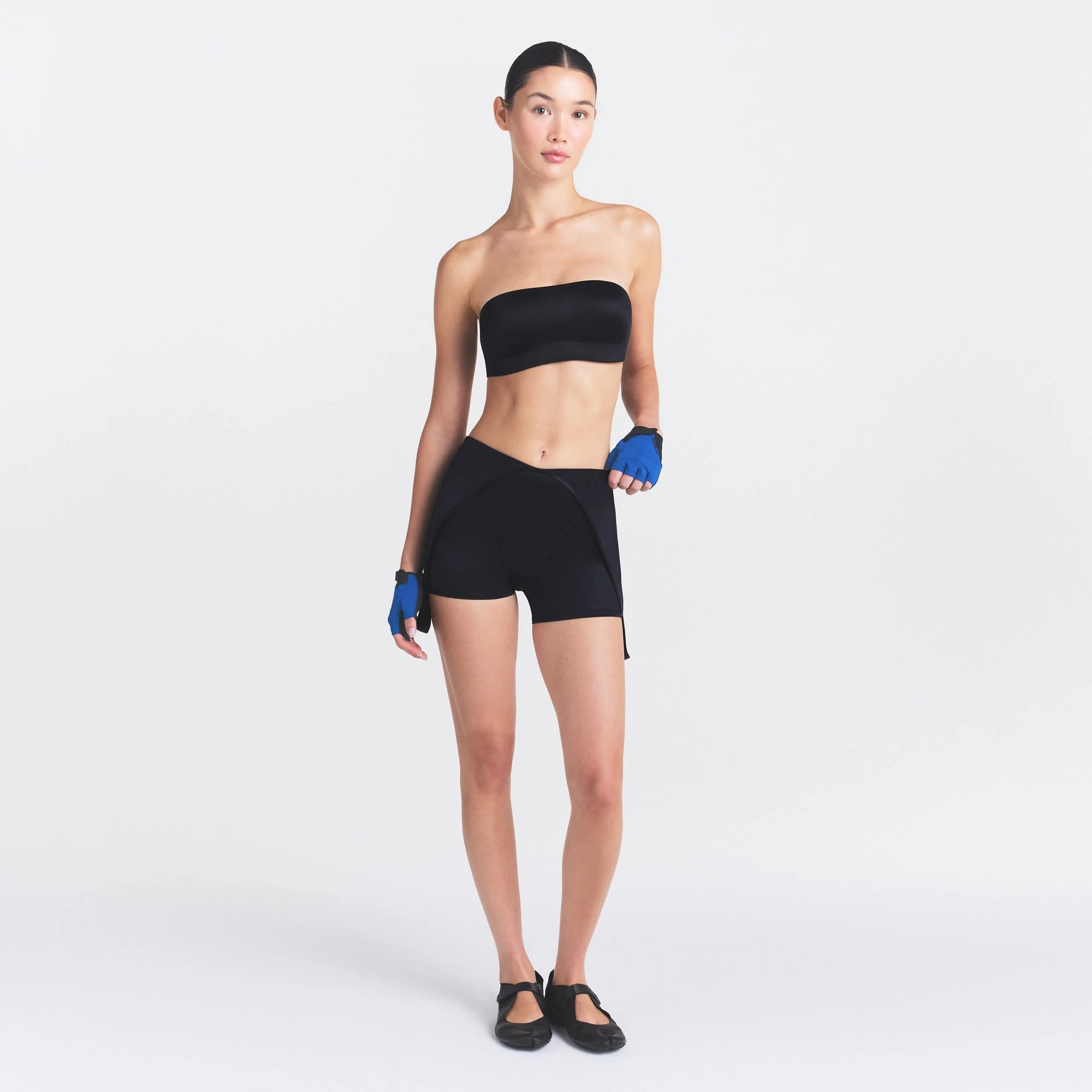 NikeSKIMS SATIN SHINE SUSPENDER 2.5" ONESIE | OBSIDIAN ON A MODEL FRONT VIEW