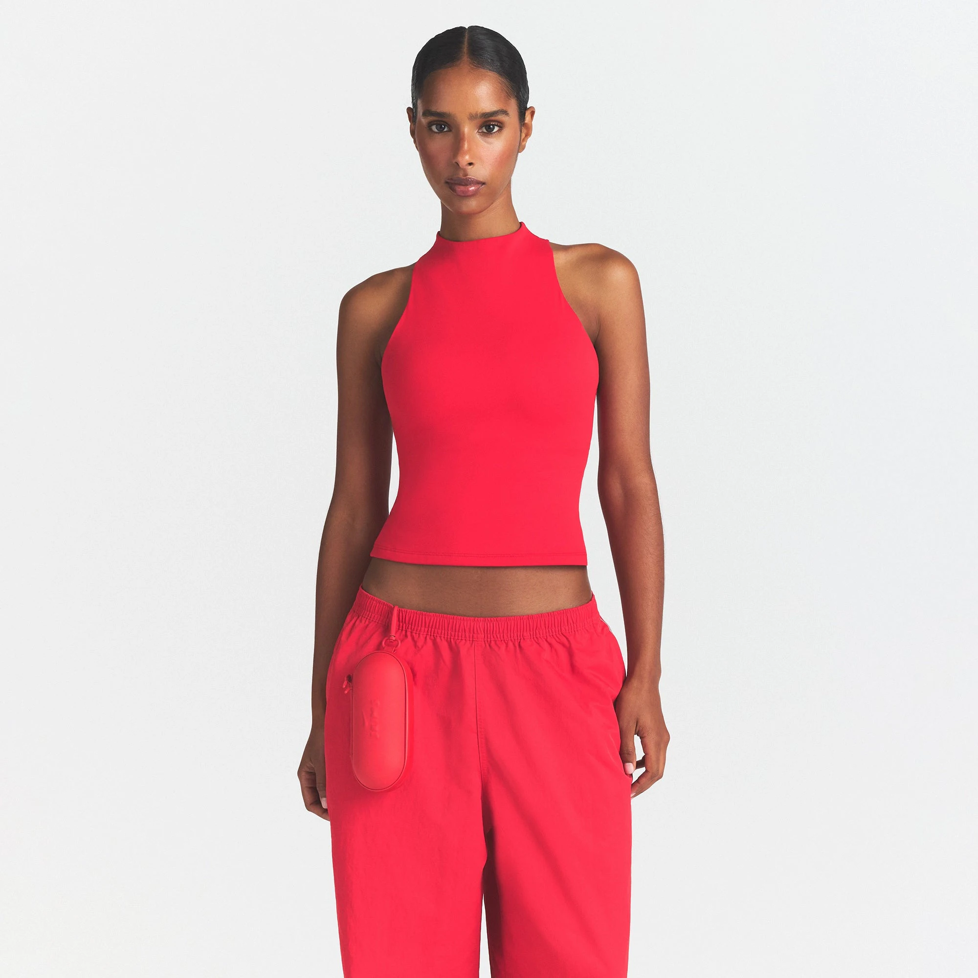 NikeSKIMS MATTE MOCK NECK RACER TANK | UNIVERSITY RED ON A MODEL SIDE VIEW @ | FOCUS: 0.0, 1.0, 0.9