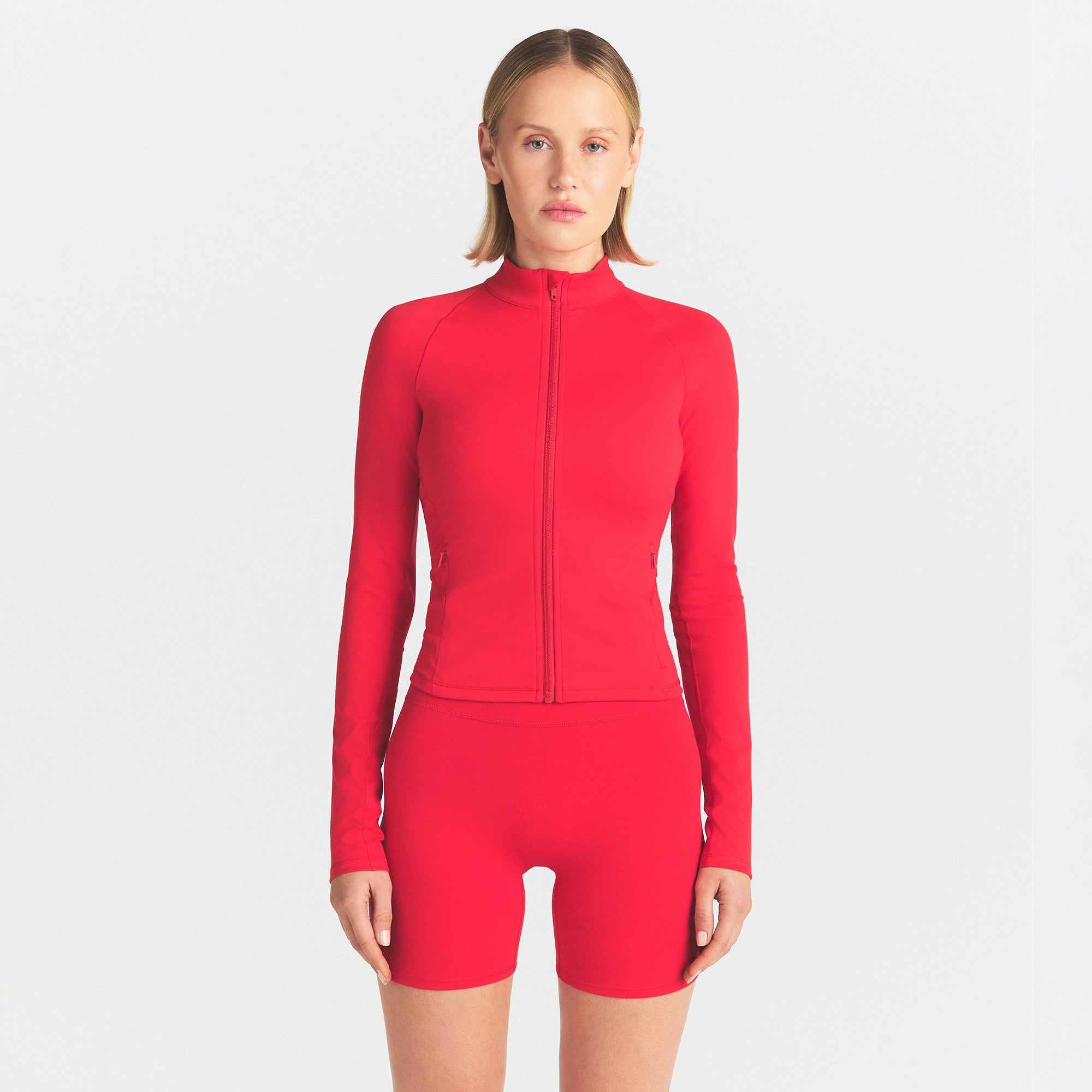 NIKESKIMS MATTE FULL ZIP JACKET | UNIVERSITY RED & LAYS FLAT ON A WHITE BACKGROUND | FLT