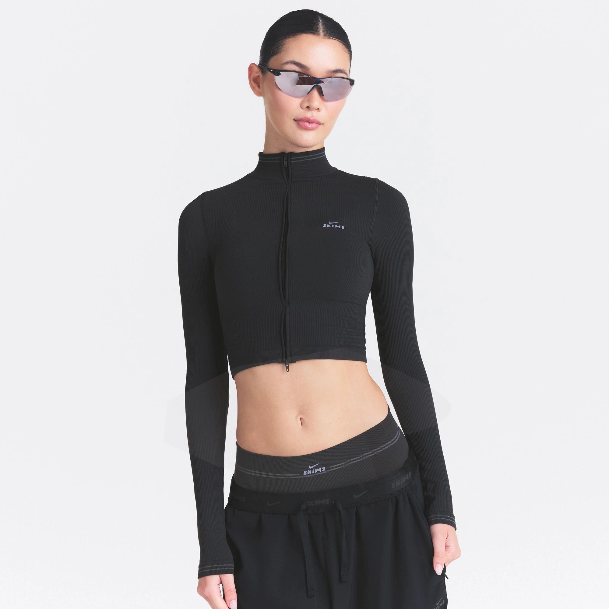 NikeSKIMS RIBBED SEAMLESS ZIP UP CROP JACKET | OBSIDIAN ON A MODEL SIDE VIEW