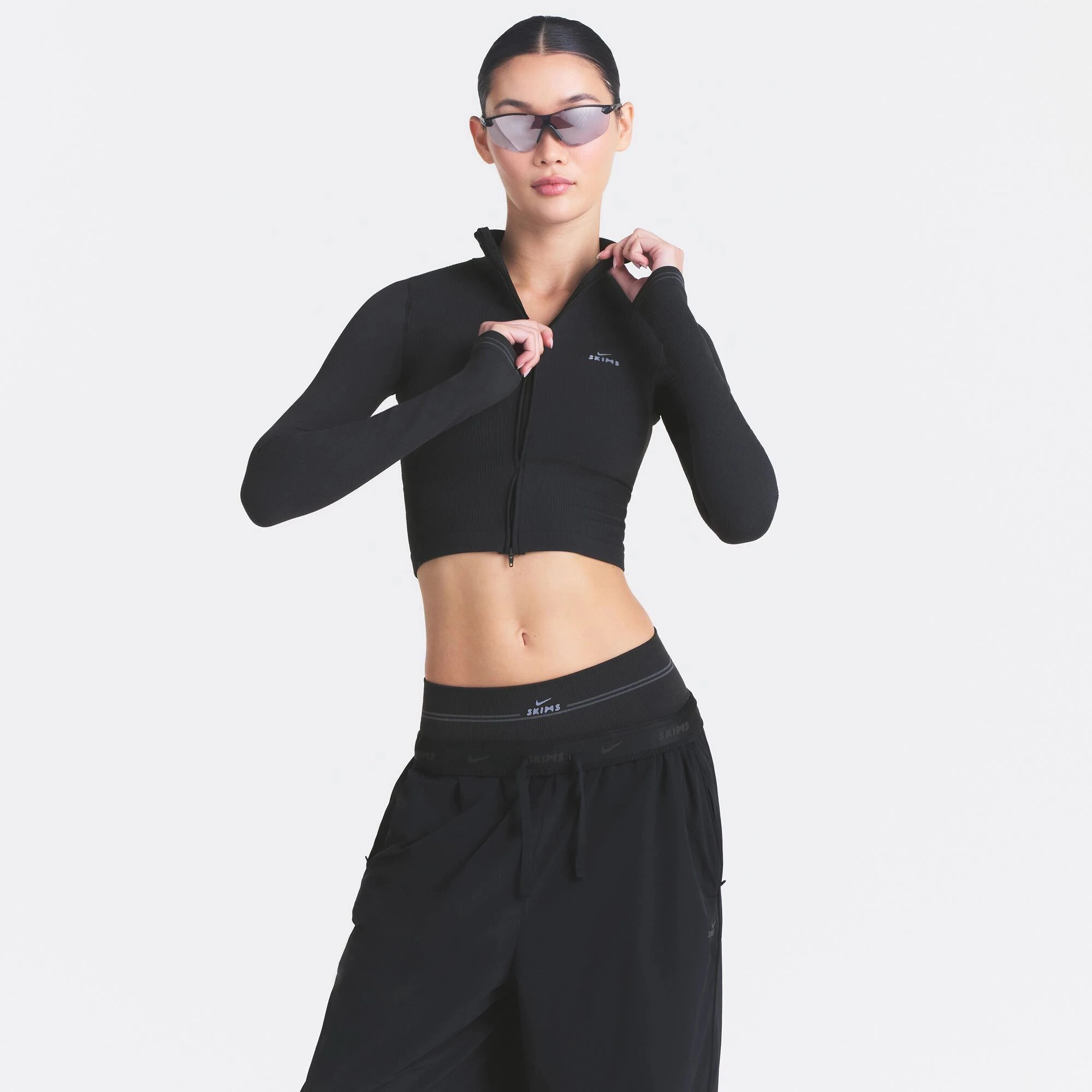 NikeSKIMS RIBBED SEAMLESS ZIP UP CROP JACKET | OBSIDIAN ON A MODEL SIDE VIEW