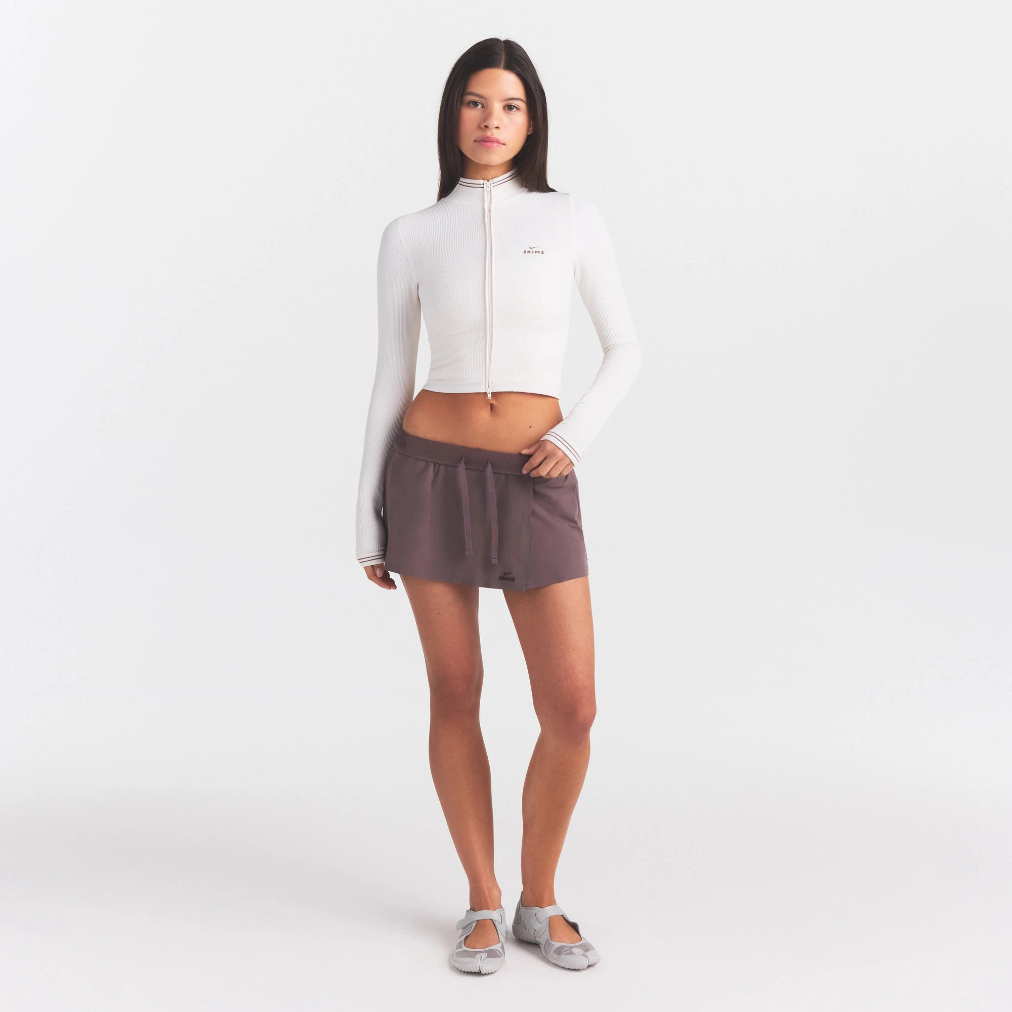 NikeSKIMS RIBBED SEAMLESS ZIP UP CROP JACKE | IVORY ON A MODEL FRONT VIEW @ | FOCUS: 0.0, 1.0, 0.9
