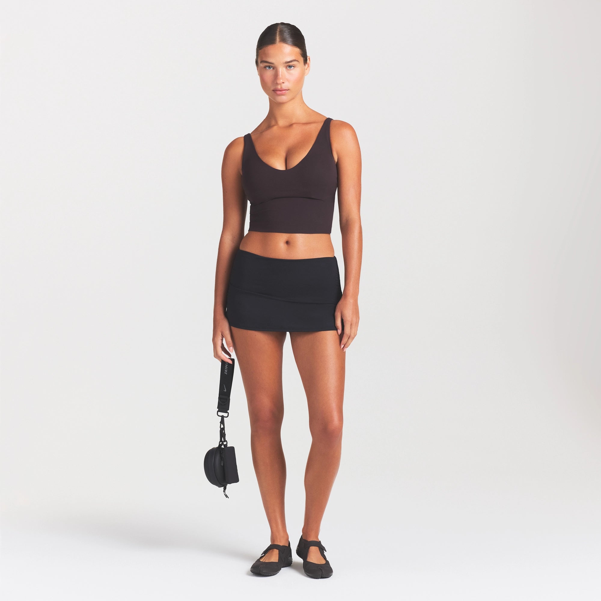 NikeSKIMS STUDIO STRETCH PLUNGE TANK | DARK ROAST ON A MODEL FRONT VIEW
