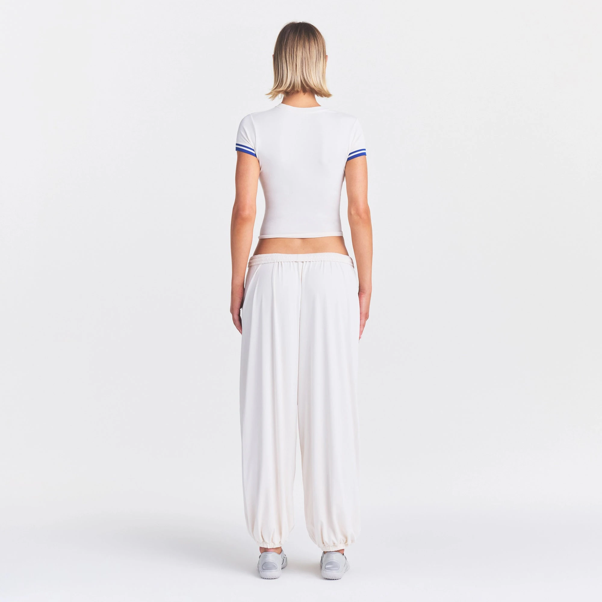 NikeSKIMS STRETCH KNIT CROPPED T-SHIRT | IVORY ON A MODEL FRONT VIEW @ | FOCUS: 0.0, 1.0, 0.9