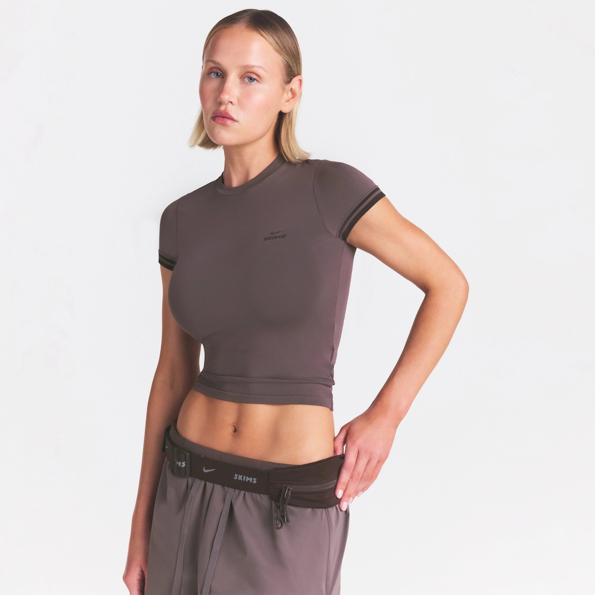 NikeSKIMS STRETCH KNIT CROPPED T-SHIRT | RESIN ON A MODEL SIDE VIEW @ | FOCUS: 0.0, 1.0, 0.9