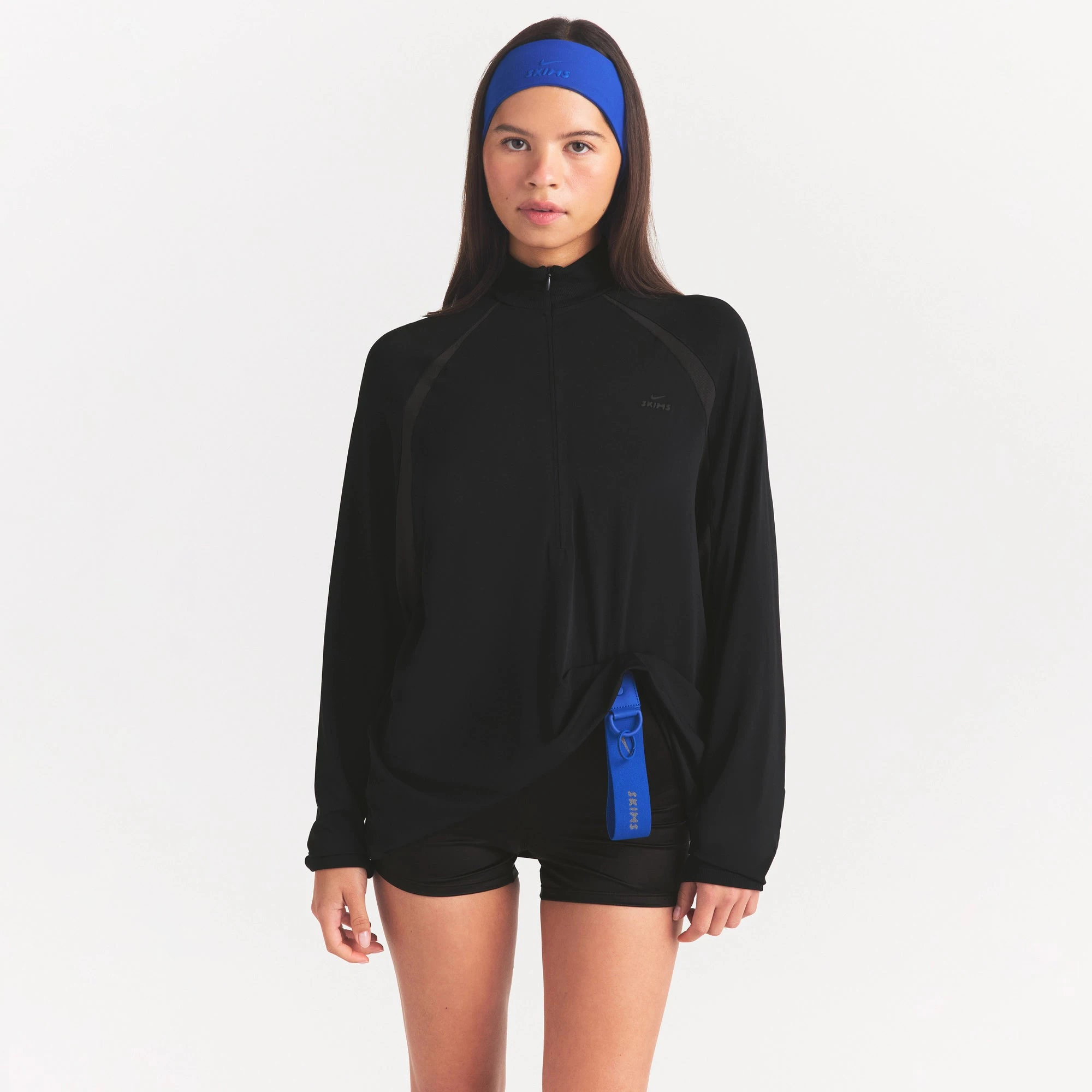NikeSKIMS STRETCH KNIT LONG SLEEVE HALF ZIP | OBSIDIAN ON A MODEL SIDE VIEW @ | FOCUS: 0.0, 1.0, 0.9