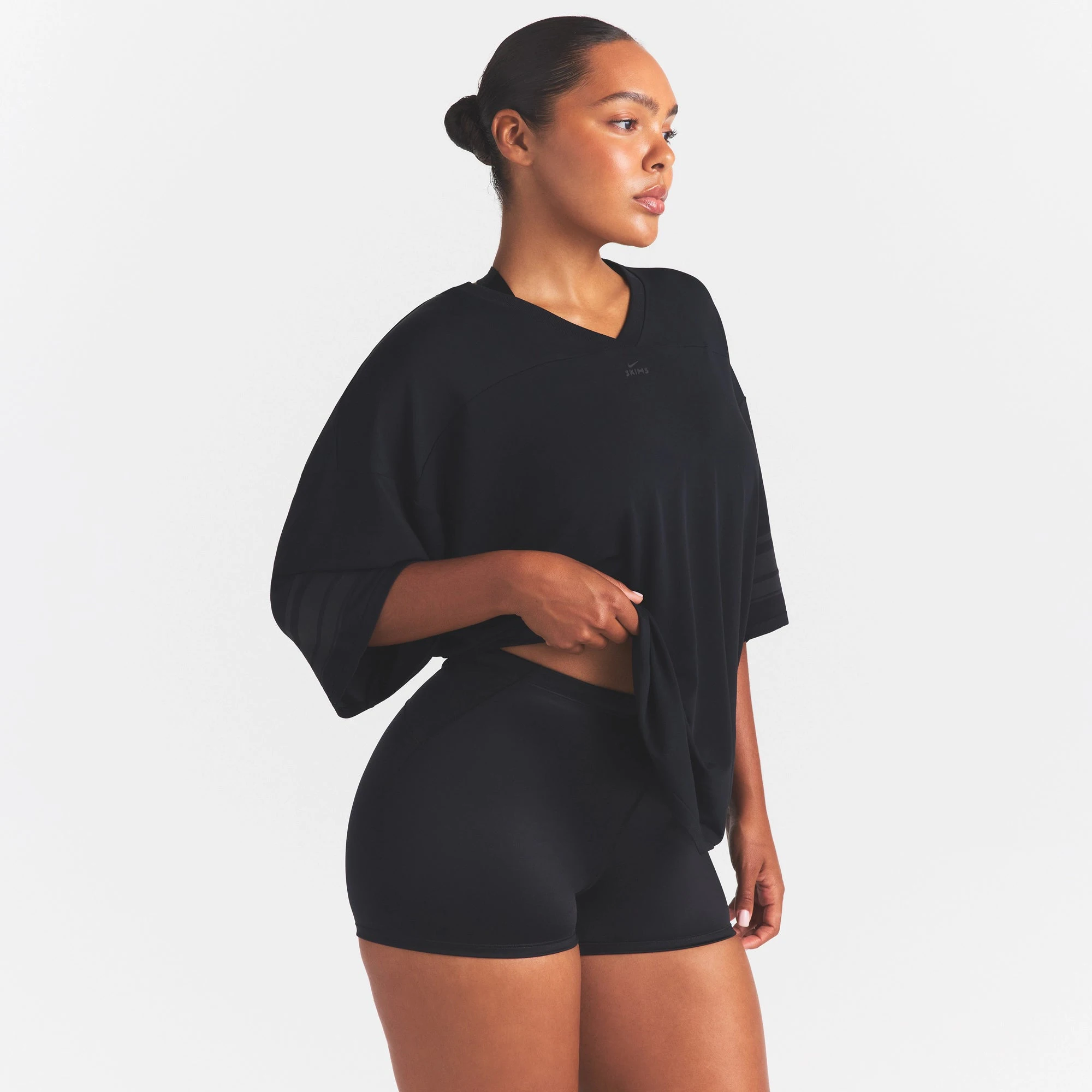NikeSKIMS STRETCH KNIT OVERSIZED V-NECK TOP | OBSIDIAN ON A MODEL SIDE VIEW @ | FOCUS: 0.0, 1.0, 0.9