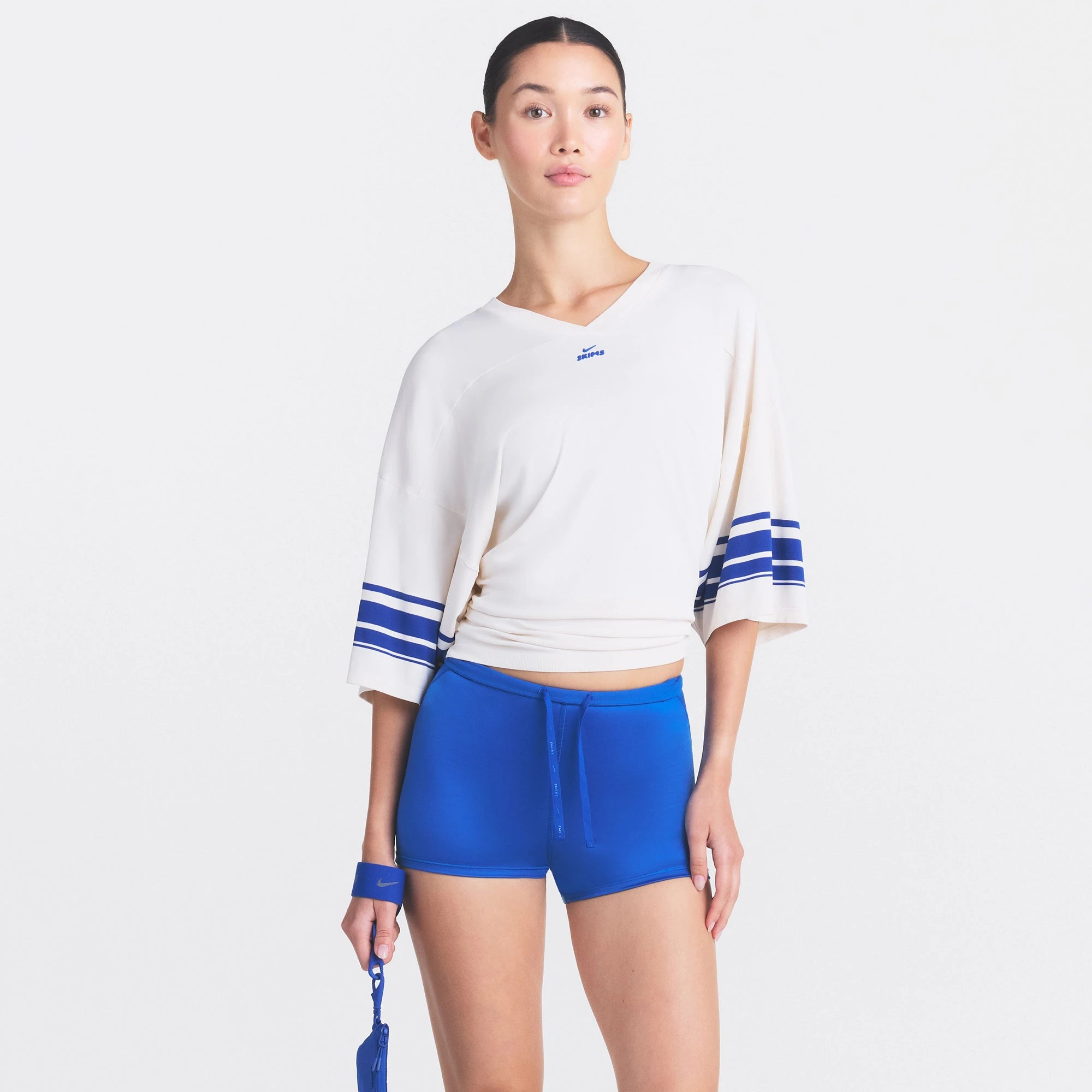 NikeSKIMS STRETCH KNIT OVERSIZED V-NECK TOP | IVORY ON A MODEL SIDE VIEW @ | FOCUS: 0.0, 1.0, 0.9