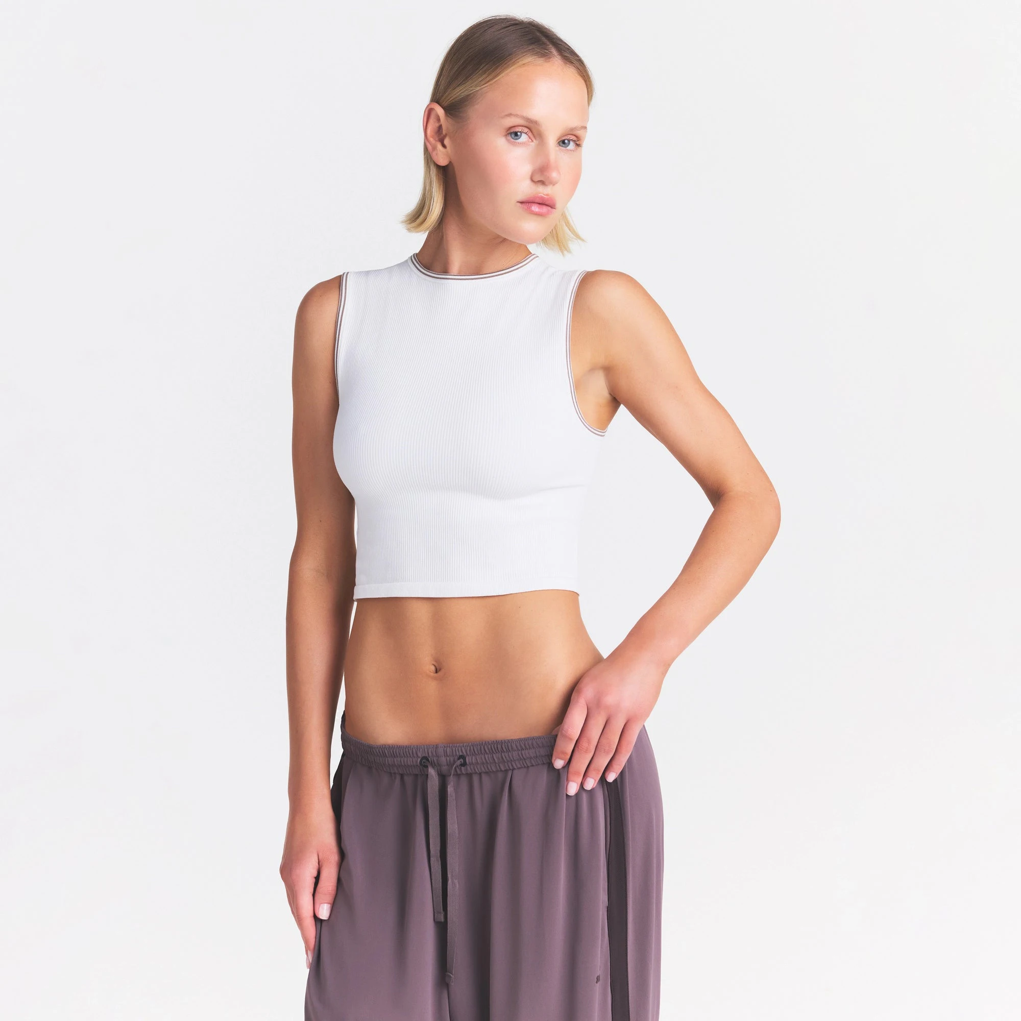 NikeSKIMS RIBBED SEAMLESS MUSCLE TANK | IVORY ON A MODEL SIDE VIEW @ | FOCUS: 0.0, 1.0, 0.9