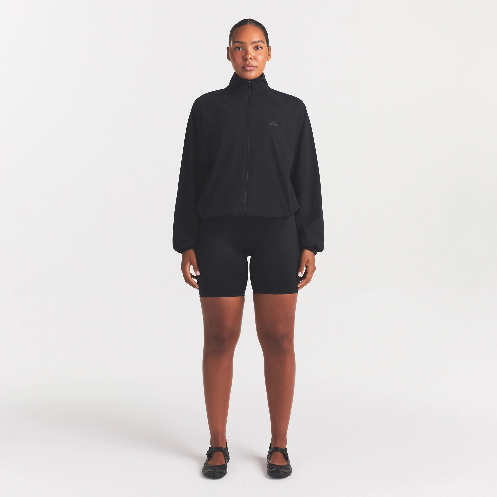 NikeSKIMS STRETCH NYLON OVERSIZED TRACK JACKET | OBSIDIAN ON A MODEL FRONT VIEW