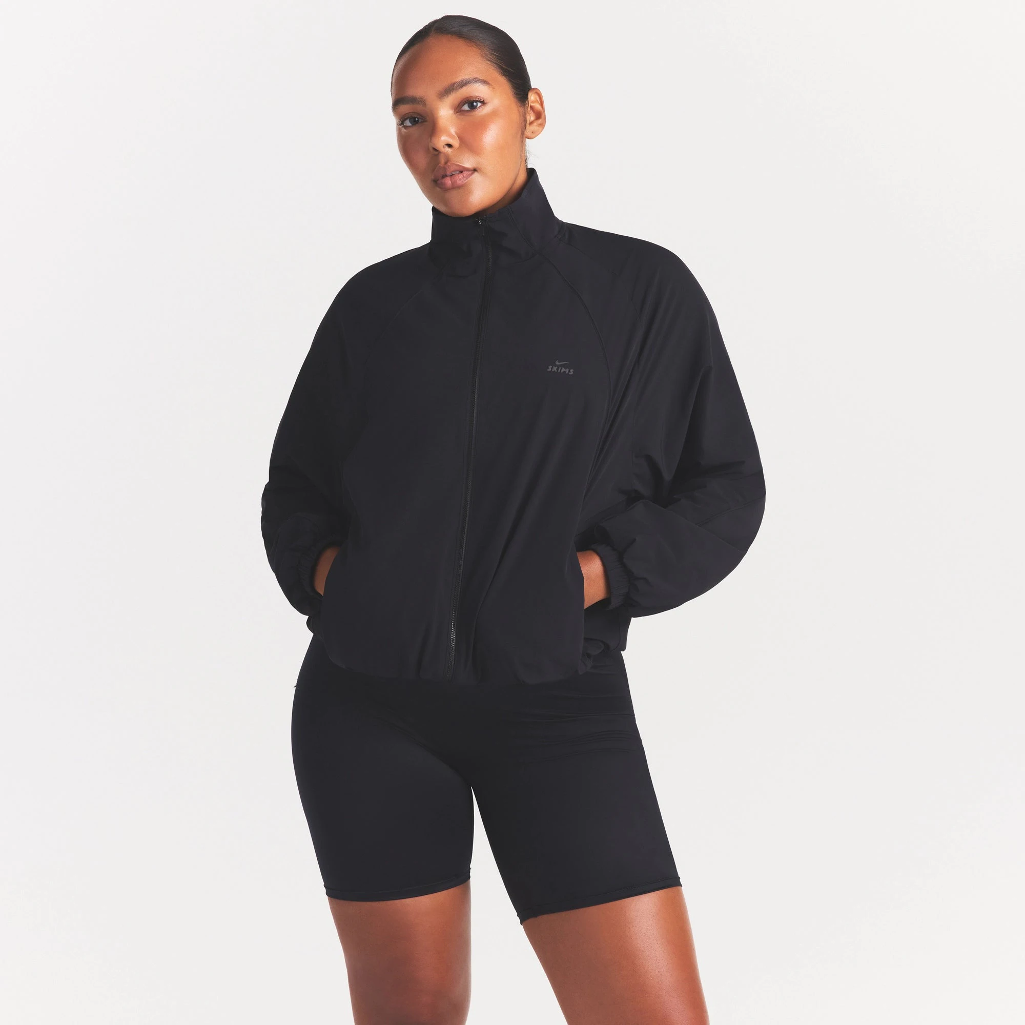 NikeSKIMS STRETCH NYLON OVERSIZED TRACK JACKET | OBSIDIAN ON A MODEL SIDE VIEW
