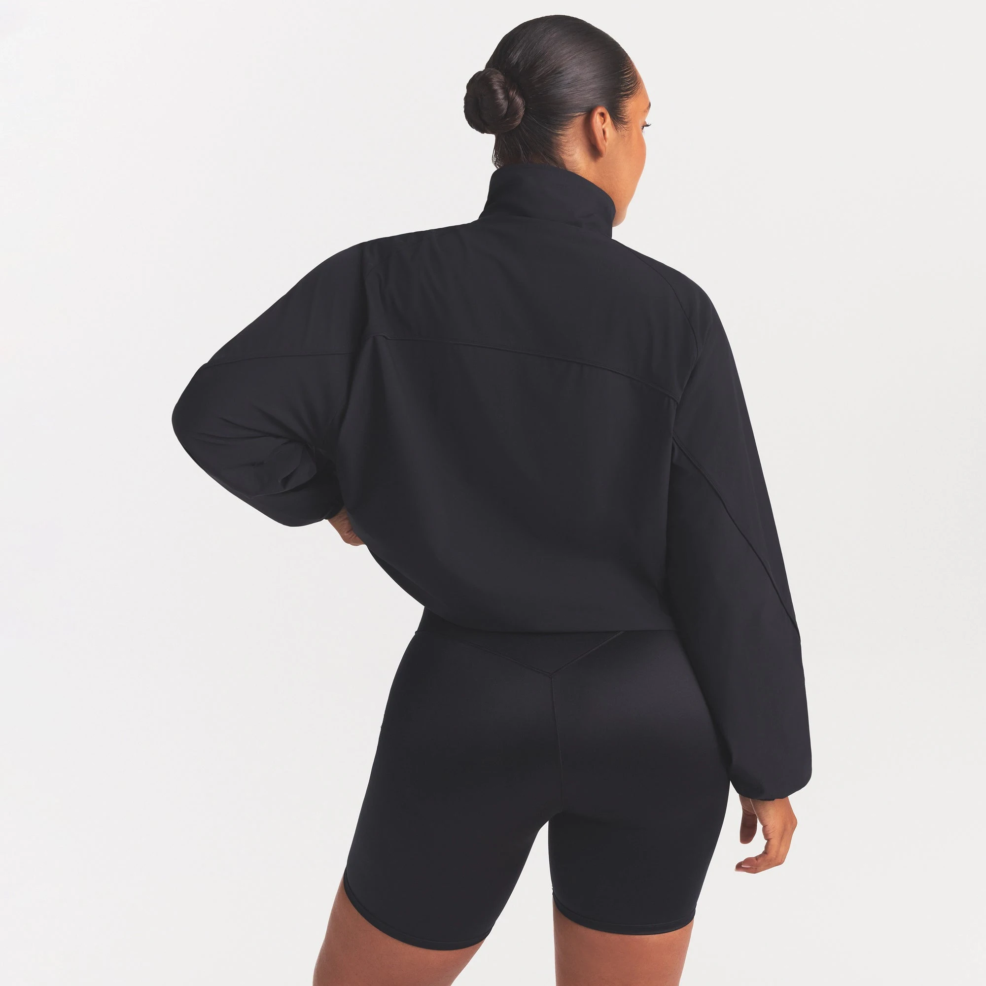 NikeSKIMS STRETCH NYLON OVERSIZED TRACK JACKET | OBSIDIAN ON A MODEL SIDE VIEW