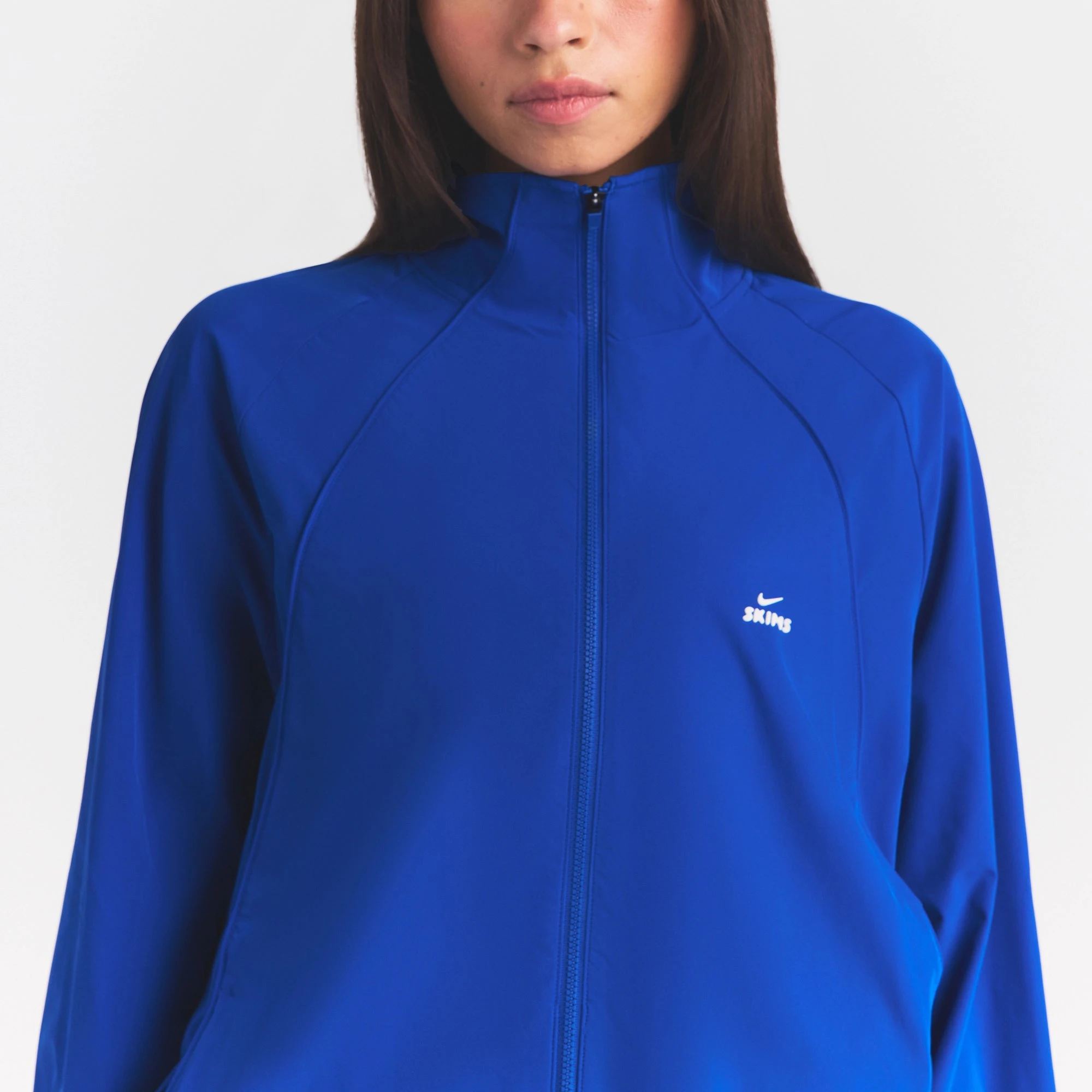 NikeSKIMS STRETCH NYLON OVERSIZED JACKET | COBALT ON A MODEL SIDE VIEW @ | FOCUS: 0.0, 1.0, 0.9