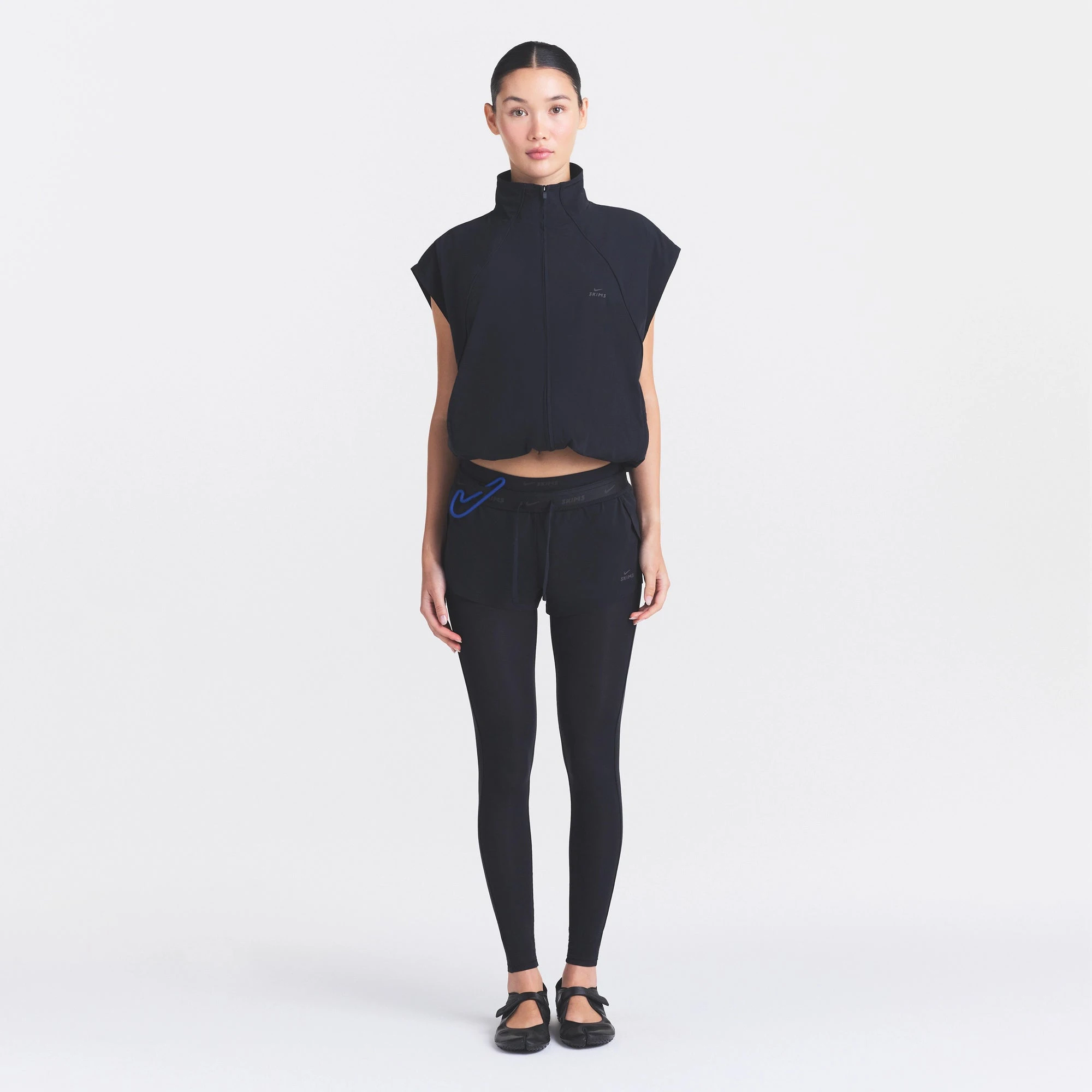 NikeSKIMS STRETCH NYLON OVERSIZED VEST | OBSIDIAN ON A MODEL FRONT VIEW @ | FOCUS: 0.0, 1.0, 0.9