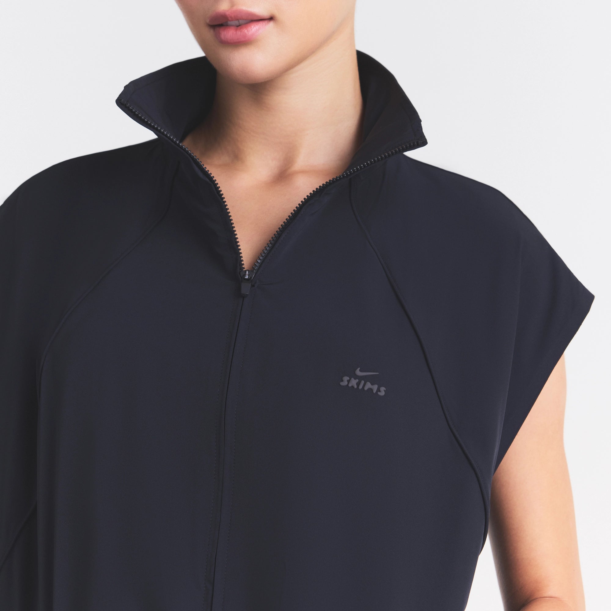 NikeSKIMS STRETCH NYLON OVERSIZED VEST | OBSIDIAN ON A MODEL SIDE VIEW @ | FOCUS: 0.0, 1.0, 0.9