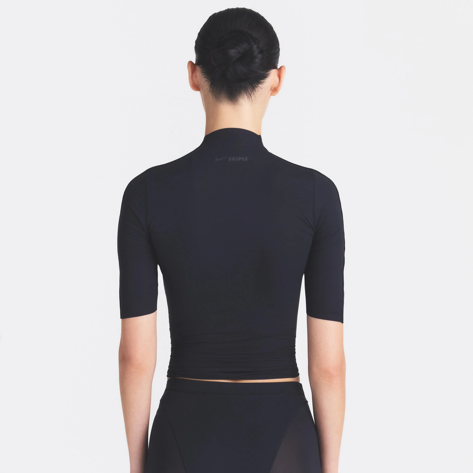 NikeSKIMS WEIGHTLESS LAYERS MOCK NECK SHORT SLEEVE T-SHIRT | OBSIDIAN ON A MODEL SIDE VIEW @ | FOCUS: 0.0, 1.0, 0.9