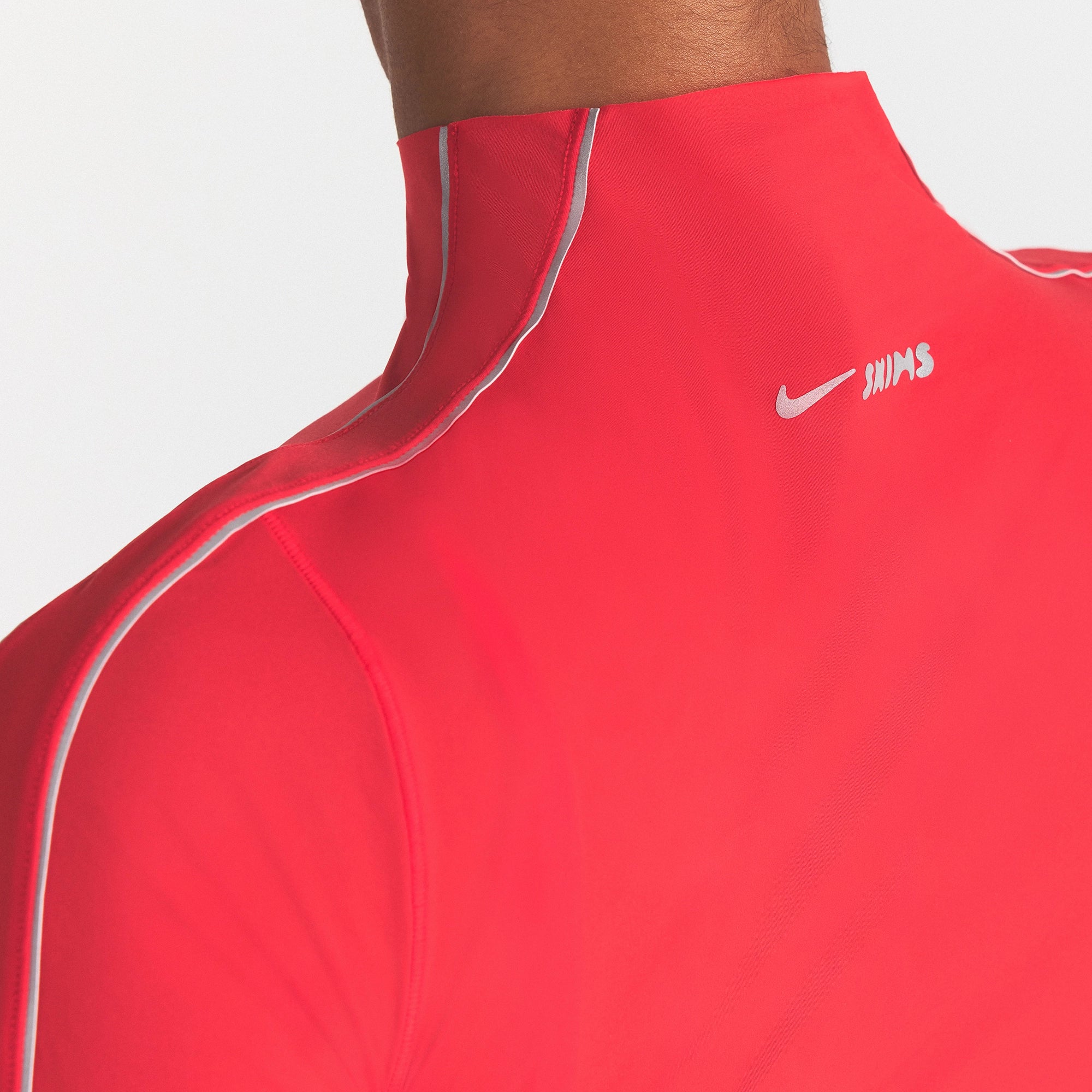 NikeSKIMS WEIGHTLESS LAYERS MOCK NECK SHORT SLEEVE T-SHIRT | UNIVERSITY RED ON A MODEL SIDE VIEW @ | FOCUS: 0.0, 1.0, 0.9
