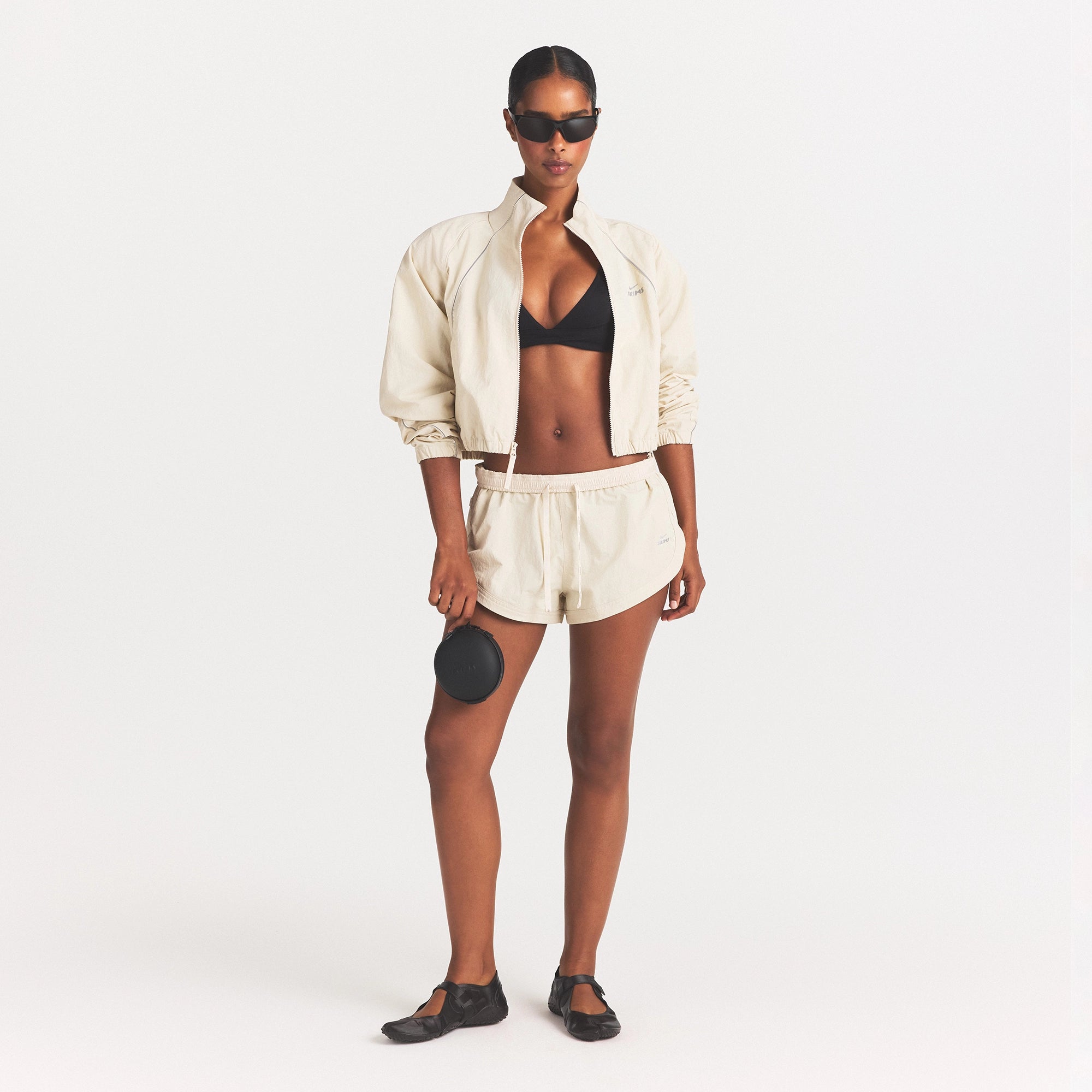 NikeSKIMS CRUNCHY NYLON CROP JACKET | PARCHMENT ON A MODEL FRONT VIEW @ | FOCUS: 0.0, 1.0, 0.9