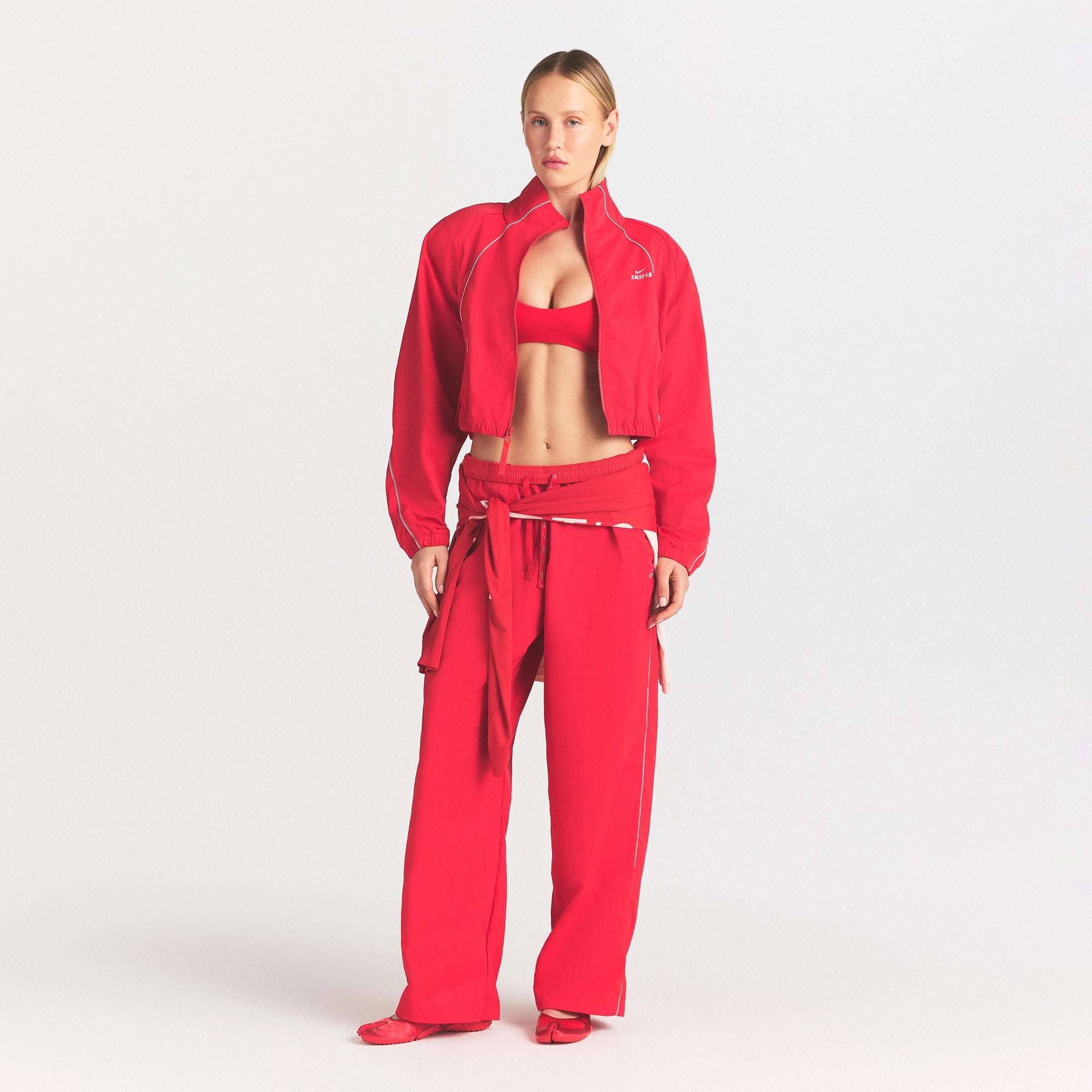 NikeSKIMS CRUNCHY NYLON CROP JACKET | UNIVERSITY RED ON A MODEL FRONT VIEW @ | FOCUS: 0.0, 1.0, 0.9