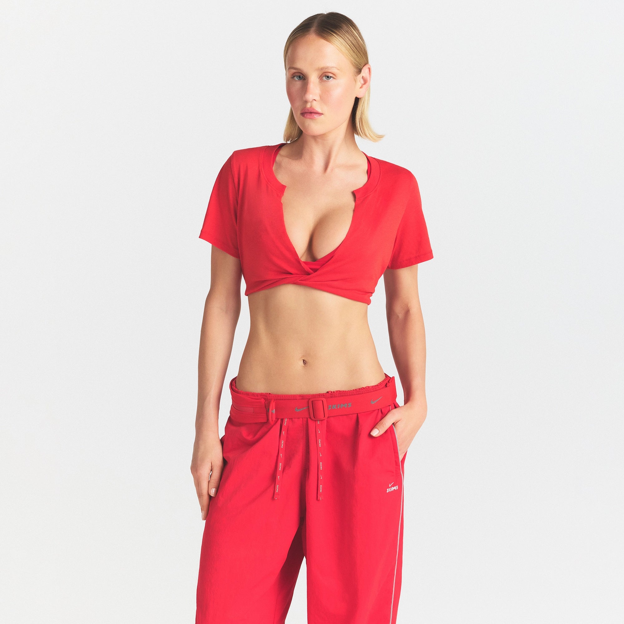 NikeSKIMS PERFORMANCE COTTON BLEND SHORT SLEEVE V-NECK CROP TOP | UNIVERSITY RED ON A MODEL SIDE VIEW @ | FOCUS: 0.0, 1.0, 0.9