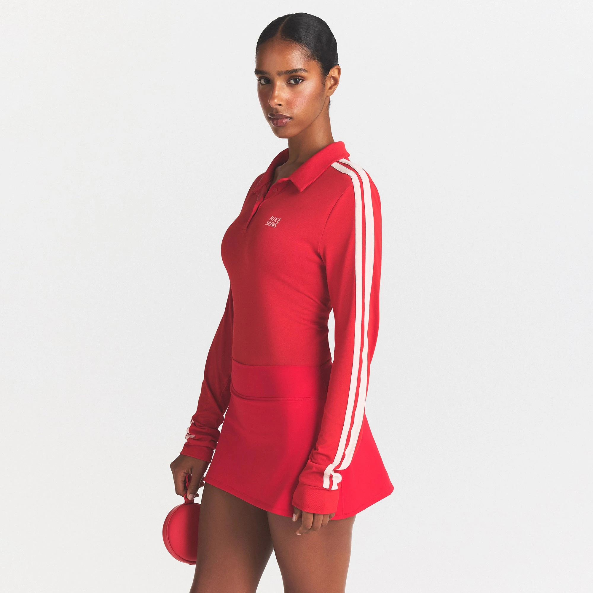 NikeSKIMS STRETCH KNIT LONG SLEEVE POLO TOP | SPORT RED/ECRU ON A MODEL SIDE VIEW @ | FOCUS: 0.0, 1.0, 0.9