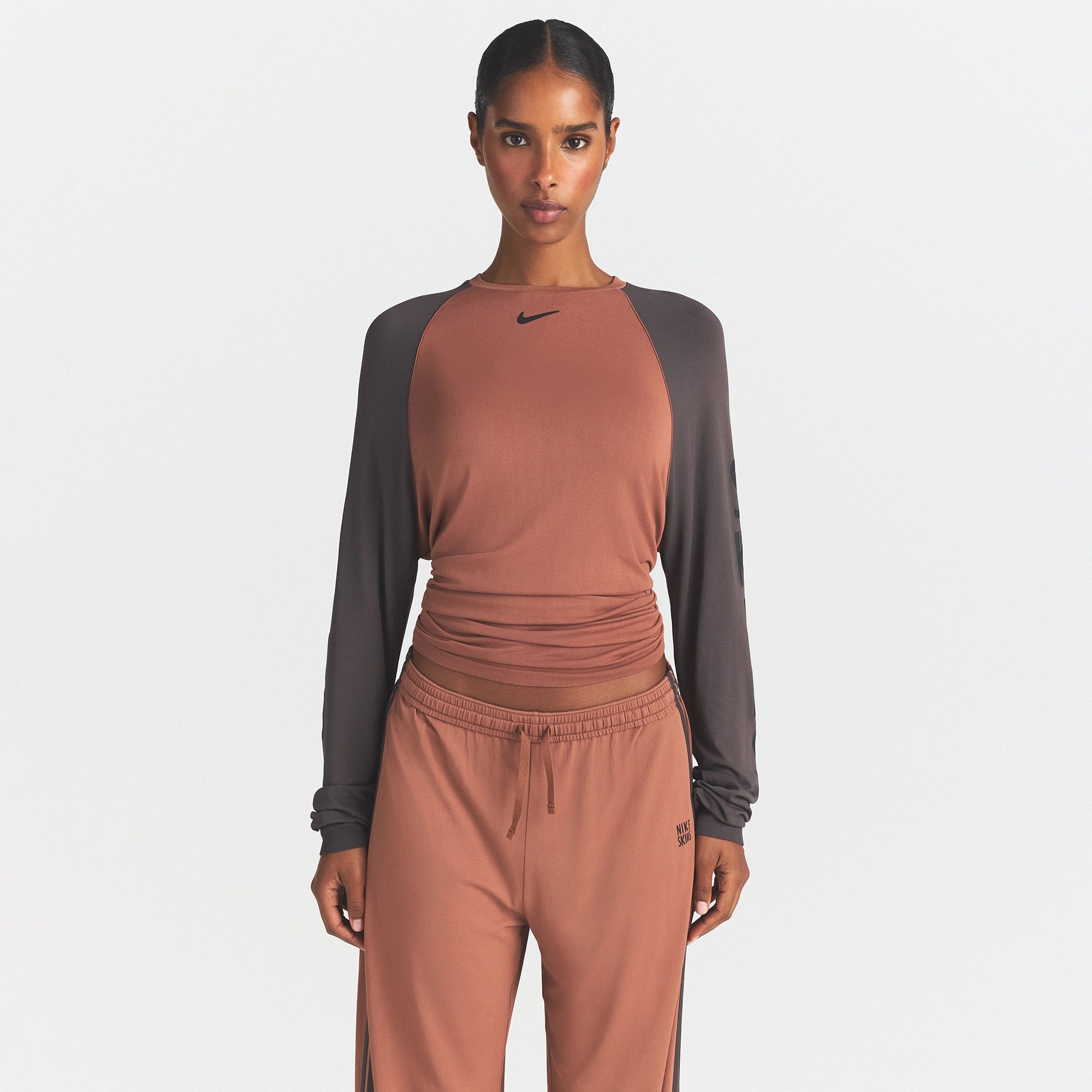 NikeSKIMS STRETCH KNIT OVERSIZED LONG SLEEVE TOP | CAROB BROWN/BOULDER ON A MODEL SIDE VIEW @ | FOCUS: 0.0, 1.0, 0.9