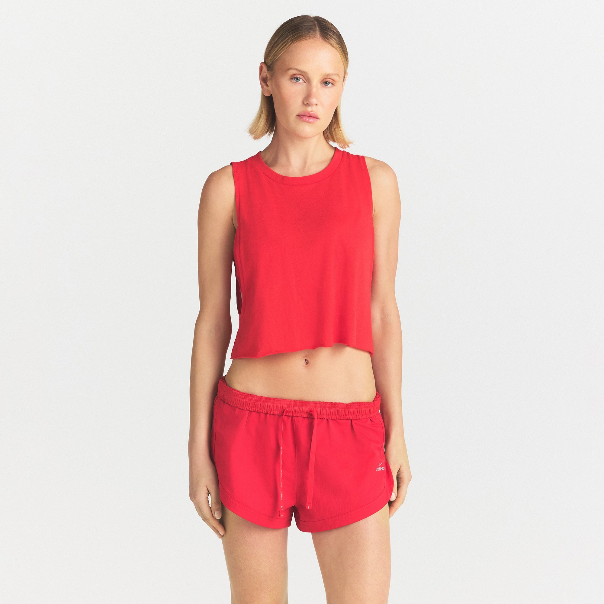 NikeSKIMS PERFORMANCE COTTON CROP TANK | UNIVERSITY RED ON A MODEL SIDE VIEW @ | FOCUS: 0.0, 1.0, 0.9