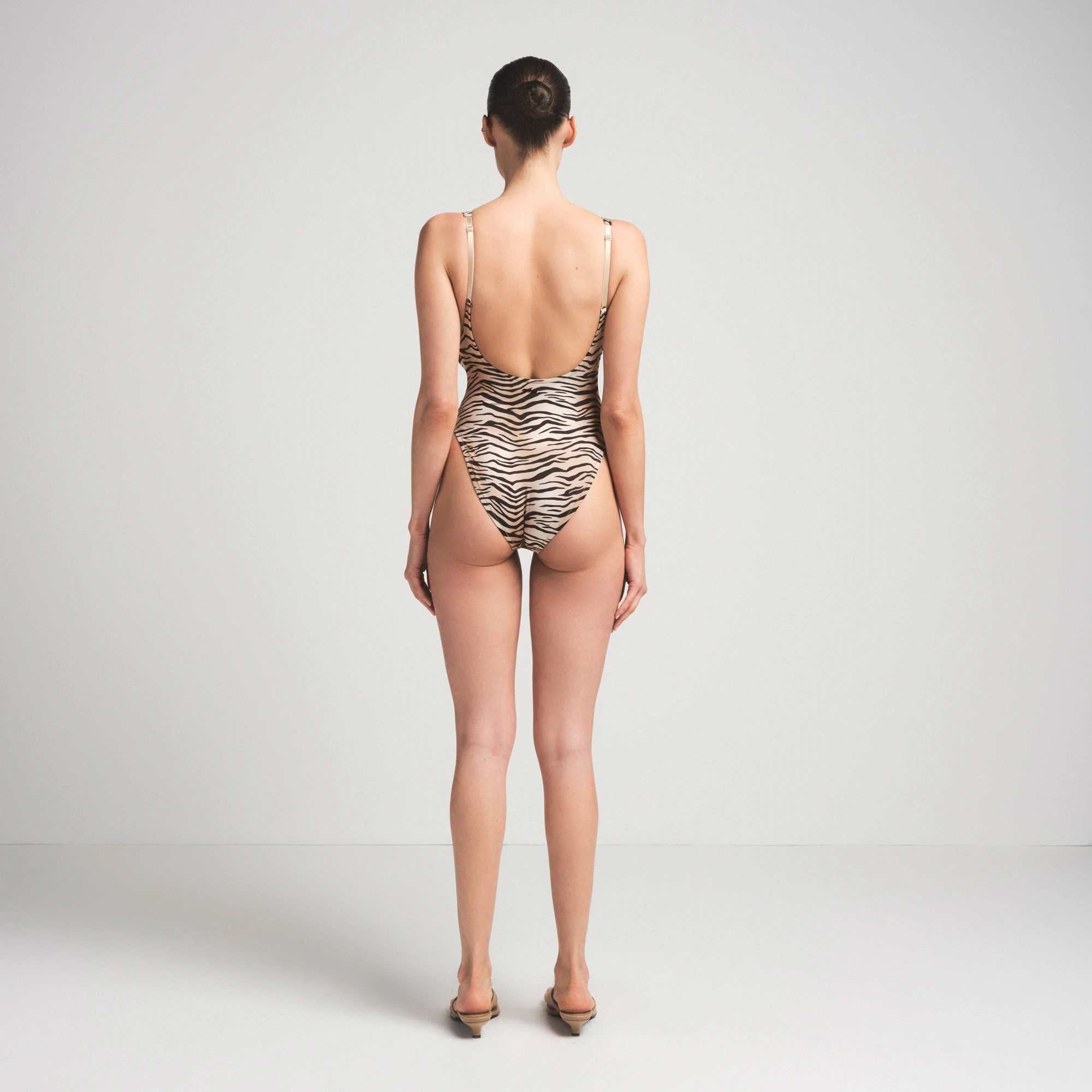 SIGNATURE SWIM SCOOP NECK ONE PIECE | CHAMPAGNE TIGER PRINT ON A MODEL SIDE VIEW | FOCUS: 0.0, 1.0, 0.9
