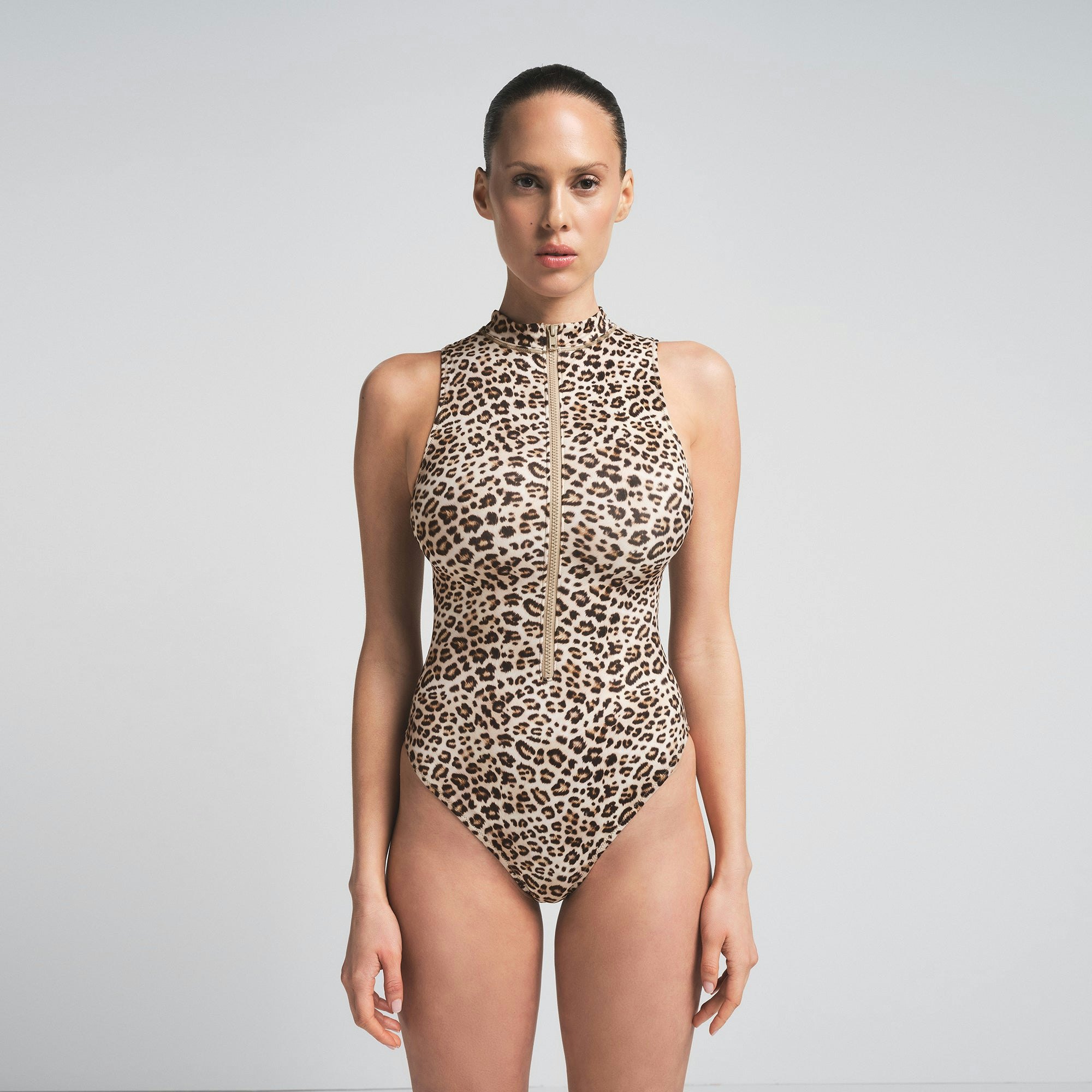 SIGNATURE SWIM ZIP FRONT ONE PIECE | CHAMPAGNE LEOPARD PRINT ON A MODEL SIDE VIEW | FOCUS: 0.0, 1.0, 0.9