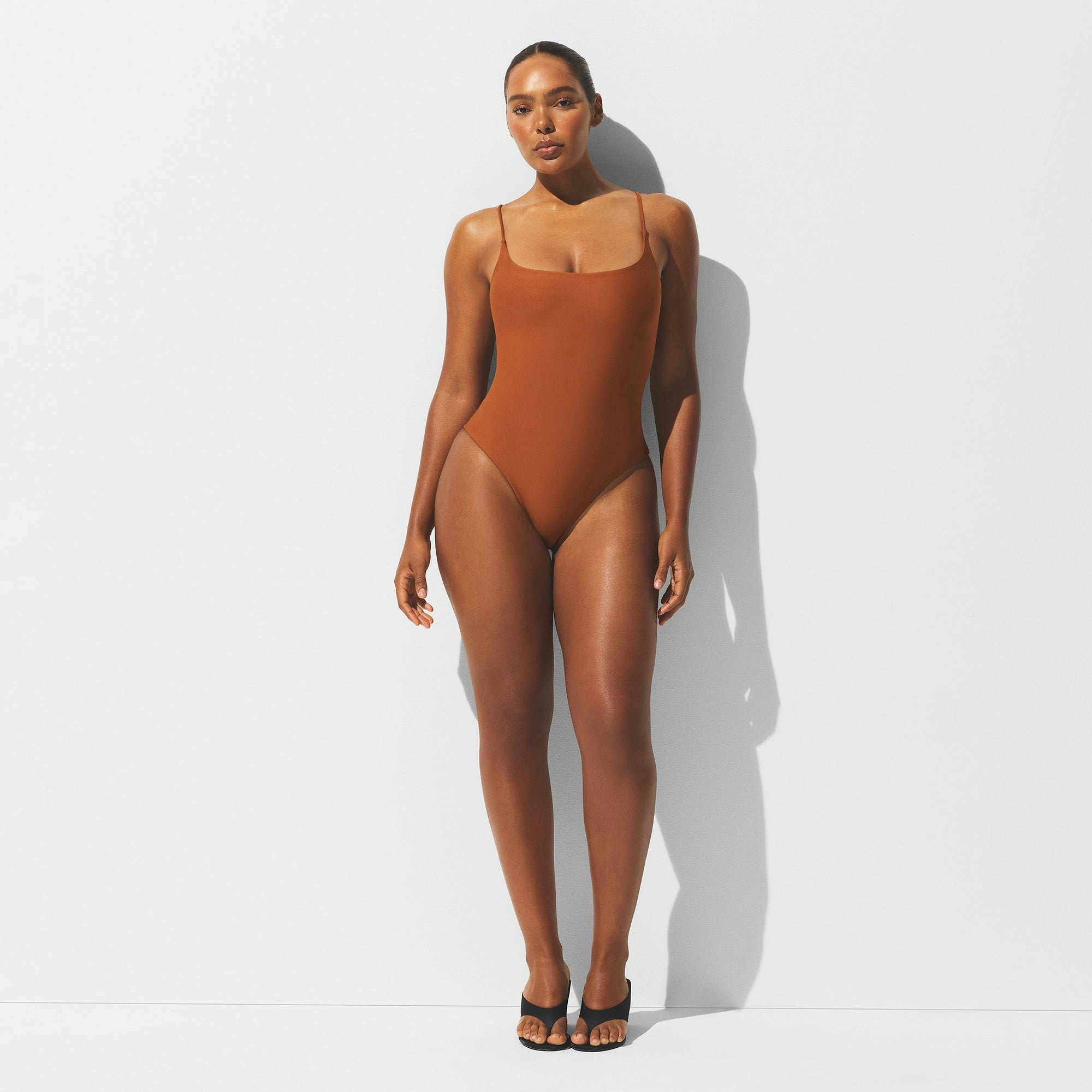 MINIMAL SWIM SQUARE NECK ONE PIECE | BRONZE ON A MODEL FRONT VIEW | FOCUS: 0.0, 1.0, 0.9