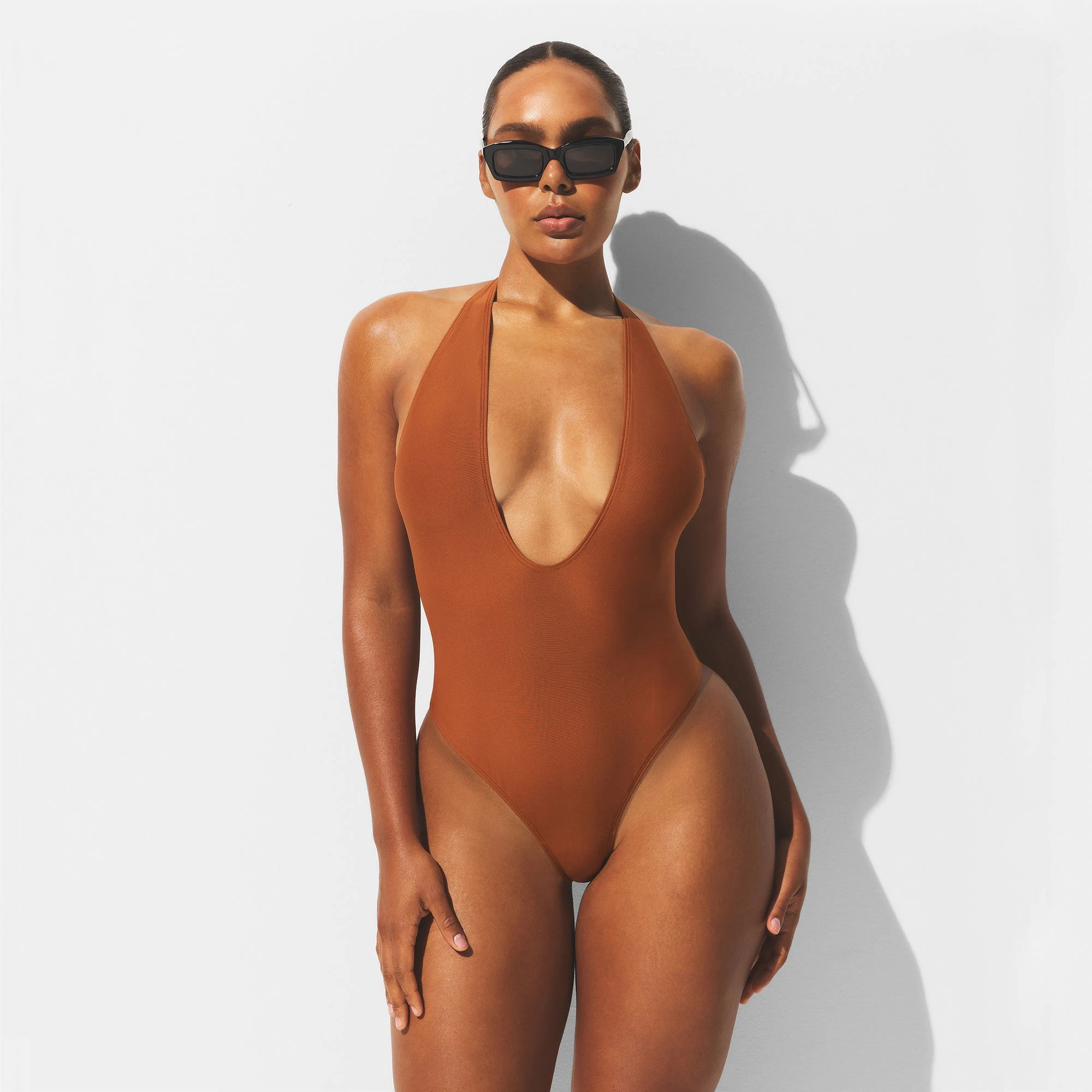 MINIMAL SWIM DEEP PLUNGE ONE PIECE | BRONZE ON A MODEL FRONT VIEW | FOCUS: 0.0, 1.0, 0.9
