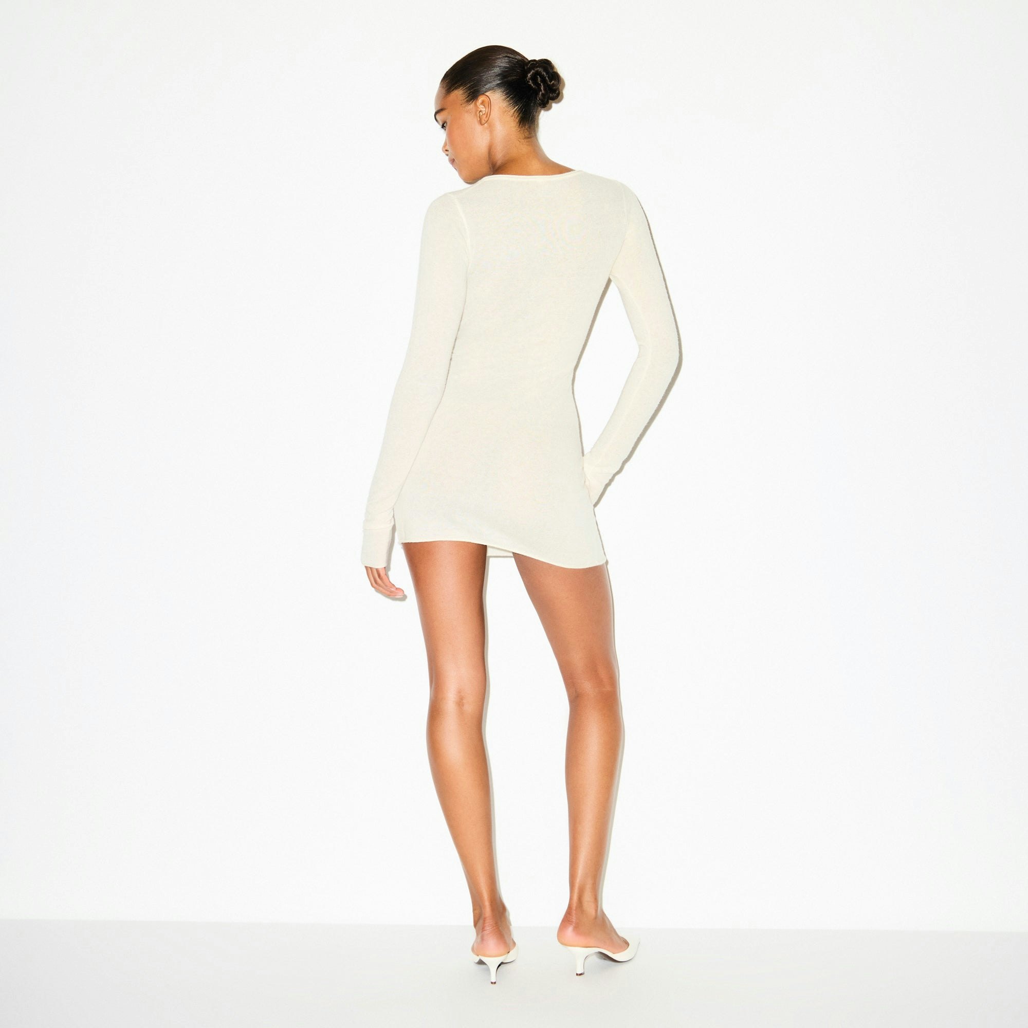 FEATHERWEIGHT CASHMERE HENLEY MINI DRESS | EGRET ON A MODEL SIDE VIEW @ | FOCUS: 0.0, 1.0, 0.9