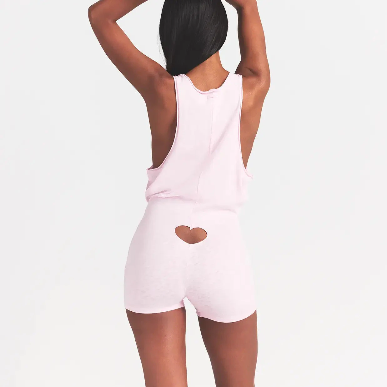 WORN IN JERSEY HEART ONESIE | BABY PINK ON A MODEL BACK VIEW @ | FOCUS: 0.0, 1.0, 0.9