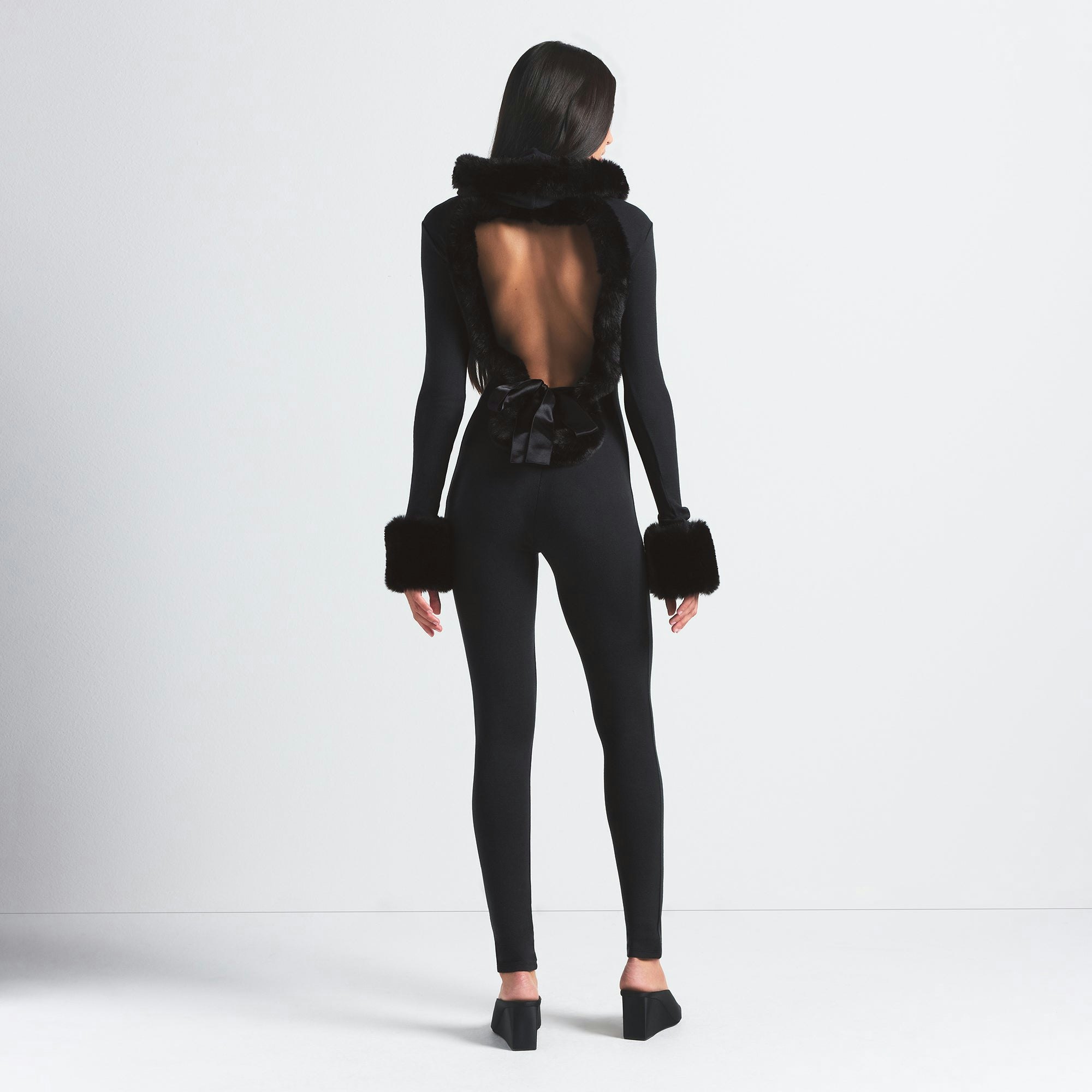 SKIMS CLOUD HOODED CATSUIT | ONYX ON A MODEL BACK VIEW @ | FOCUS: 0.0, 1.0, 0.9