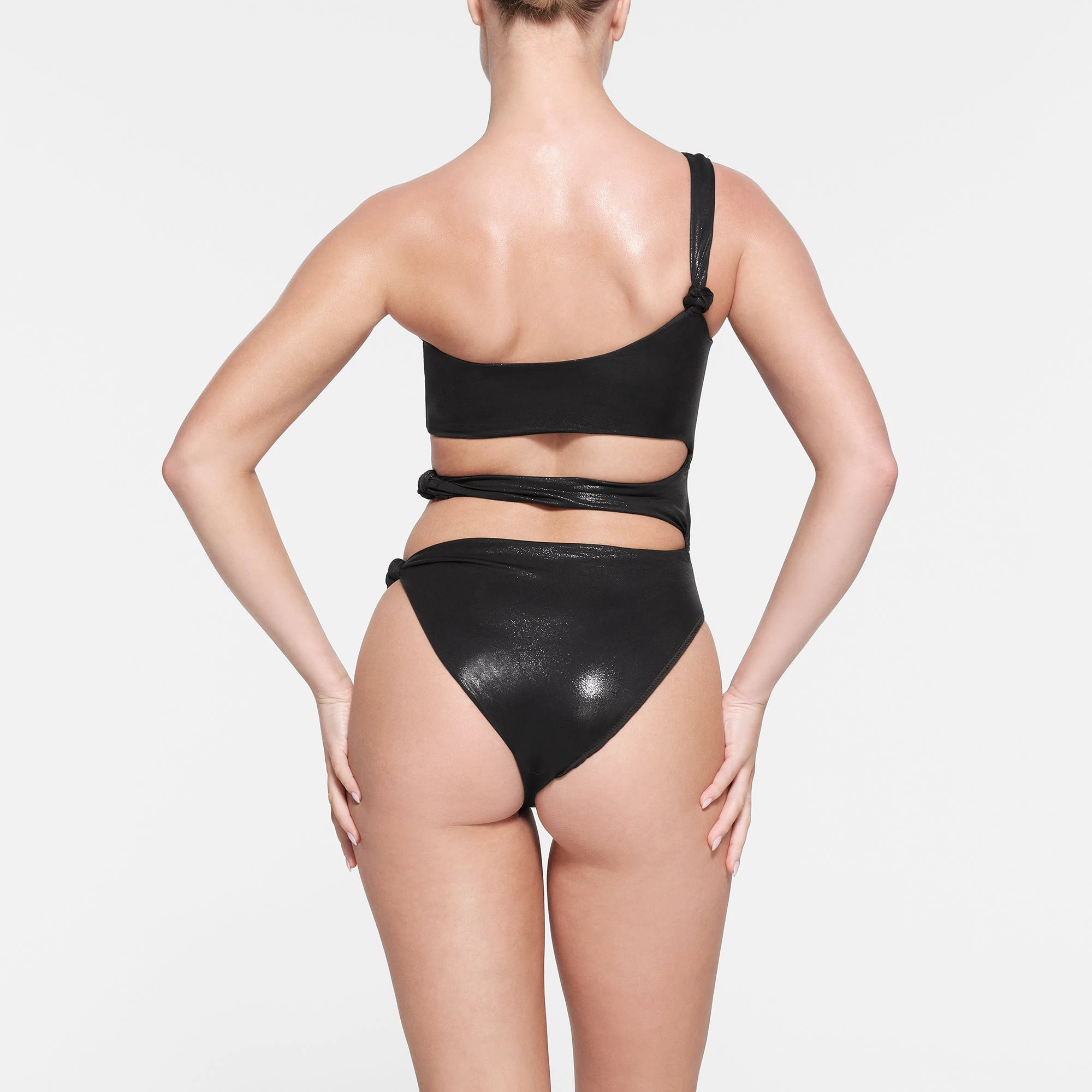 LIQUID SHINE SWIM KNOTTED ONE SHOULDER MONOKINI | ONYX ON A MODEL BACK VIEW