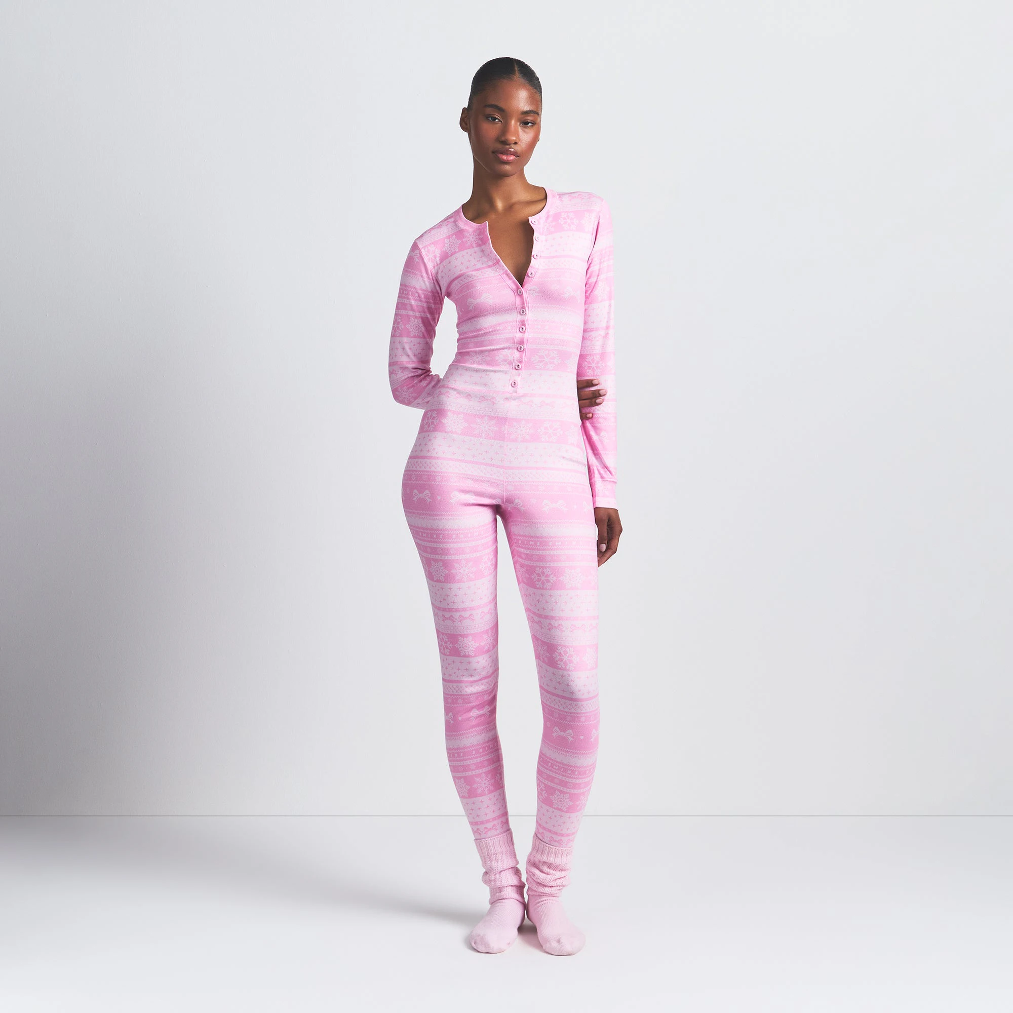 LOGO PLUSH POINTELLE HENLEY ONESIE | BUBBLE GUM BOW FAIR ISLE ON A MODEL FRONT VIEW @ | FOCUS: 0.0, 1.0, 0.9