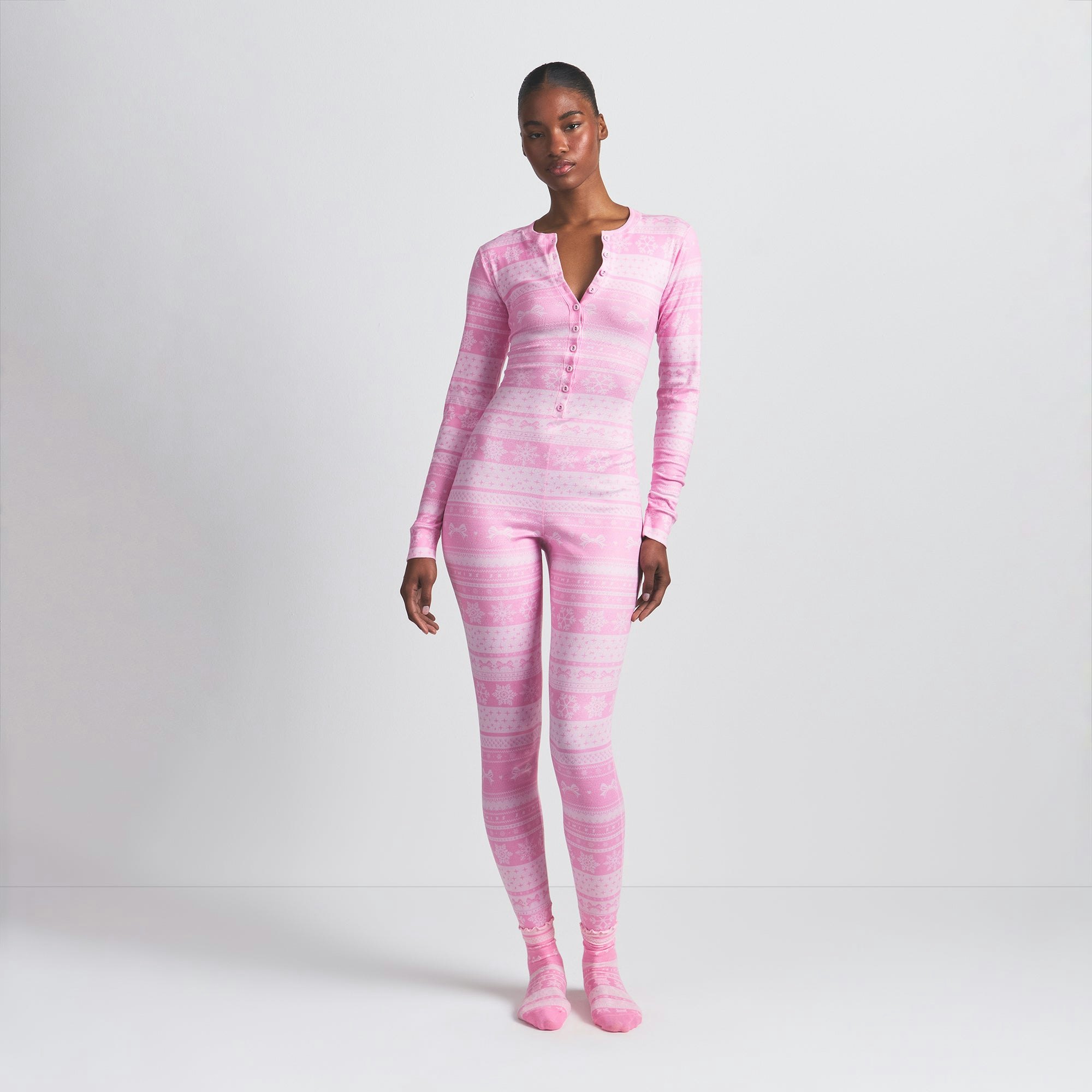 LOGO PLUSH POINTELLE HENLEY ONESIE | BUBBLE GUM BOW FAIR ISLE ON A MODEL FRONT VIEW @ | FOCUS: 0.0, 1.0, 0.9