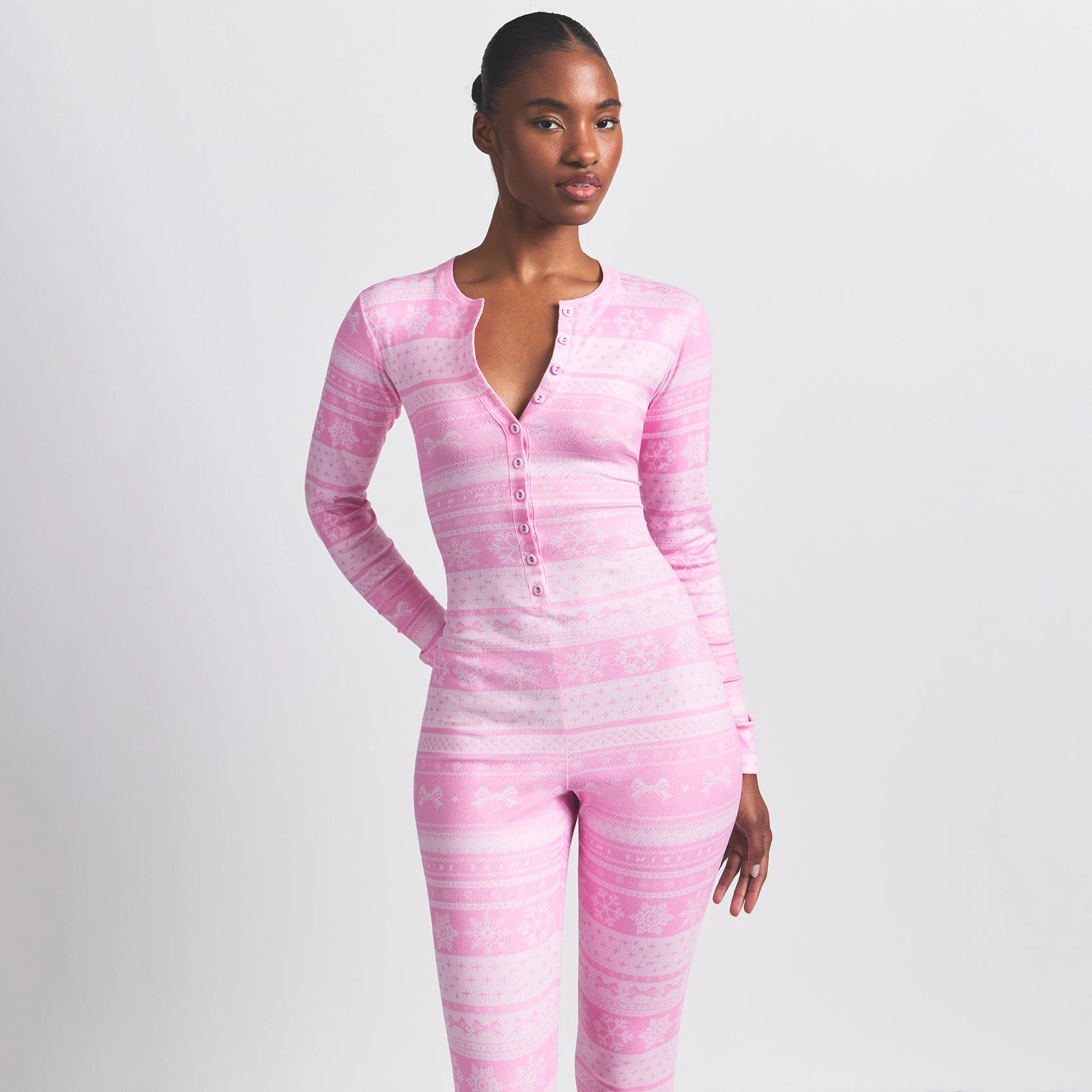 LOGO PLUSH POINTELLE HENLEY ONESIE | BUBBLE GUM BOW FAIR ISLE ON A MODEL FRONT VIEW @ | FOCUS: 0.0, 1.0, 0.9