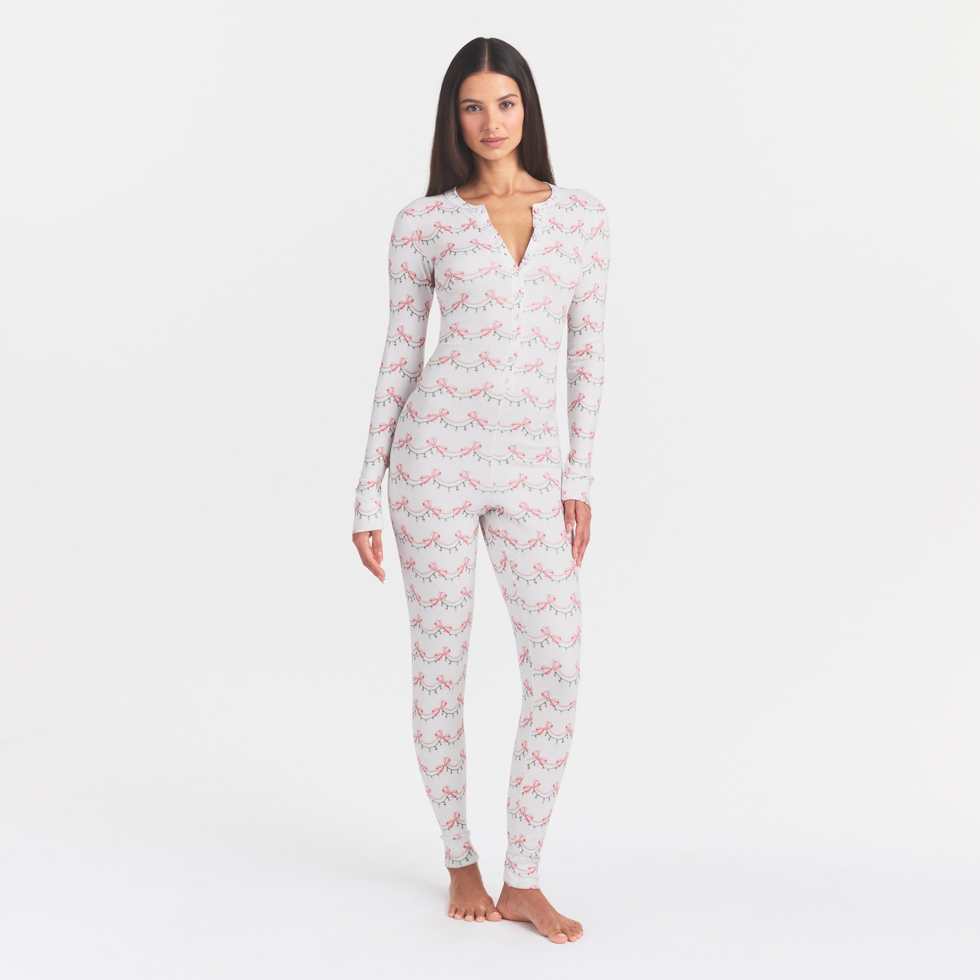 LOGO PLUSH POINTELLE ONESIE | SNOW RIBBON LIGHTS ON A MODEL FRONT VIEW @ | FOCUS: 0.0, 1.0, 0.9