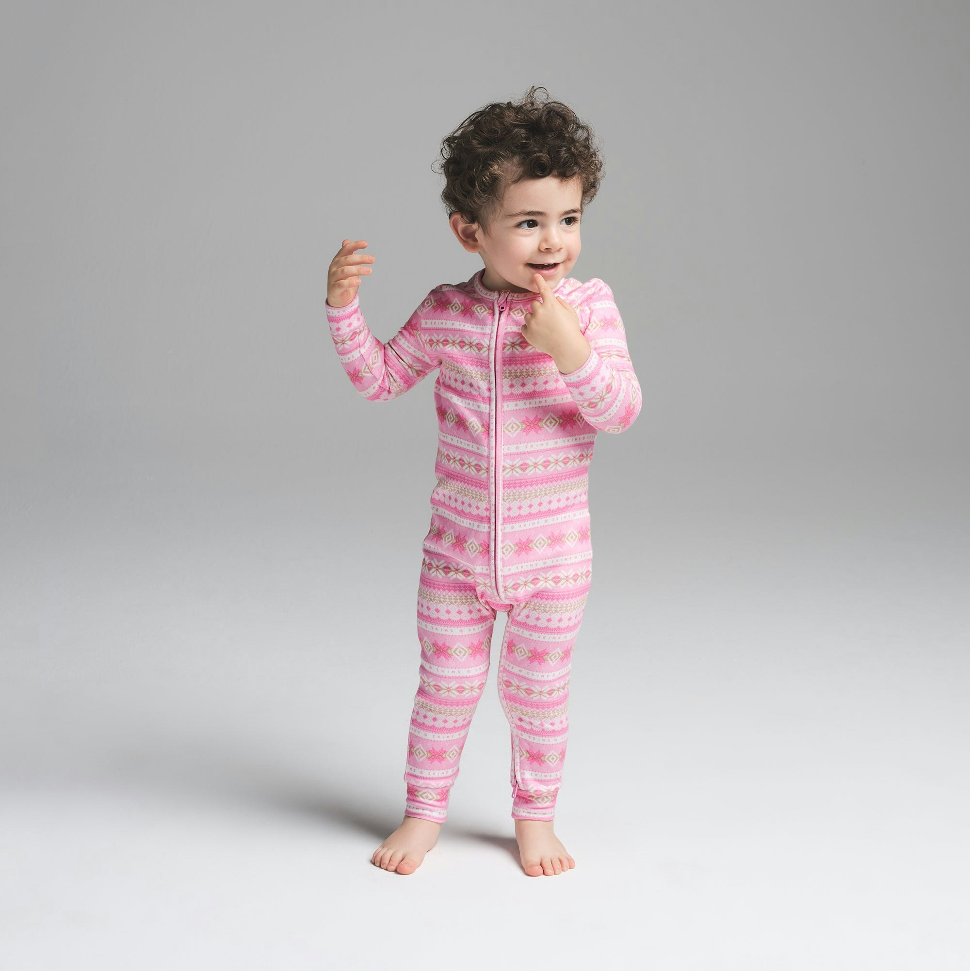 LOGO PLUSH POINTELLE BABY ONESIE | BUBBLE GUM SIENNA FAIR ISLE ON A MODEL FRONT VIEW | FOCUS: 0.0, 1.0, 0.9