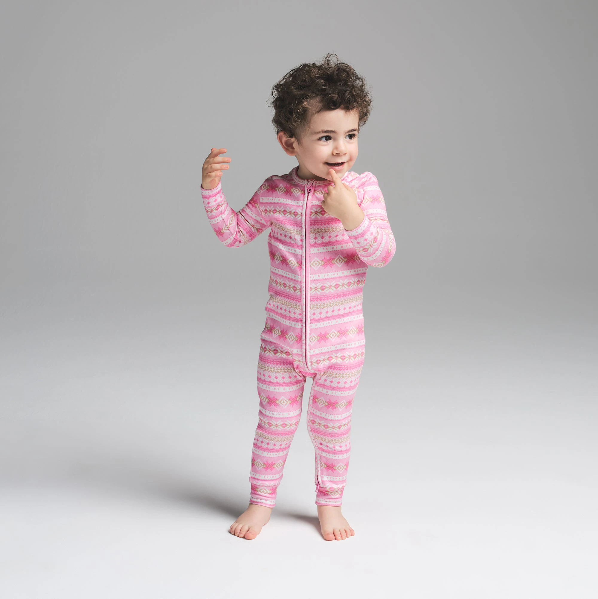 LOGO PLUSH POINTELLE BABY ONESIE | BUBBLE GUM SIENNA FAIR ISLE ON A MODEL FRONT VIEW | FOCUS: 0.0, 1.0, 0.9