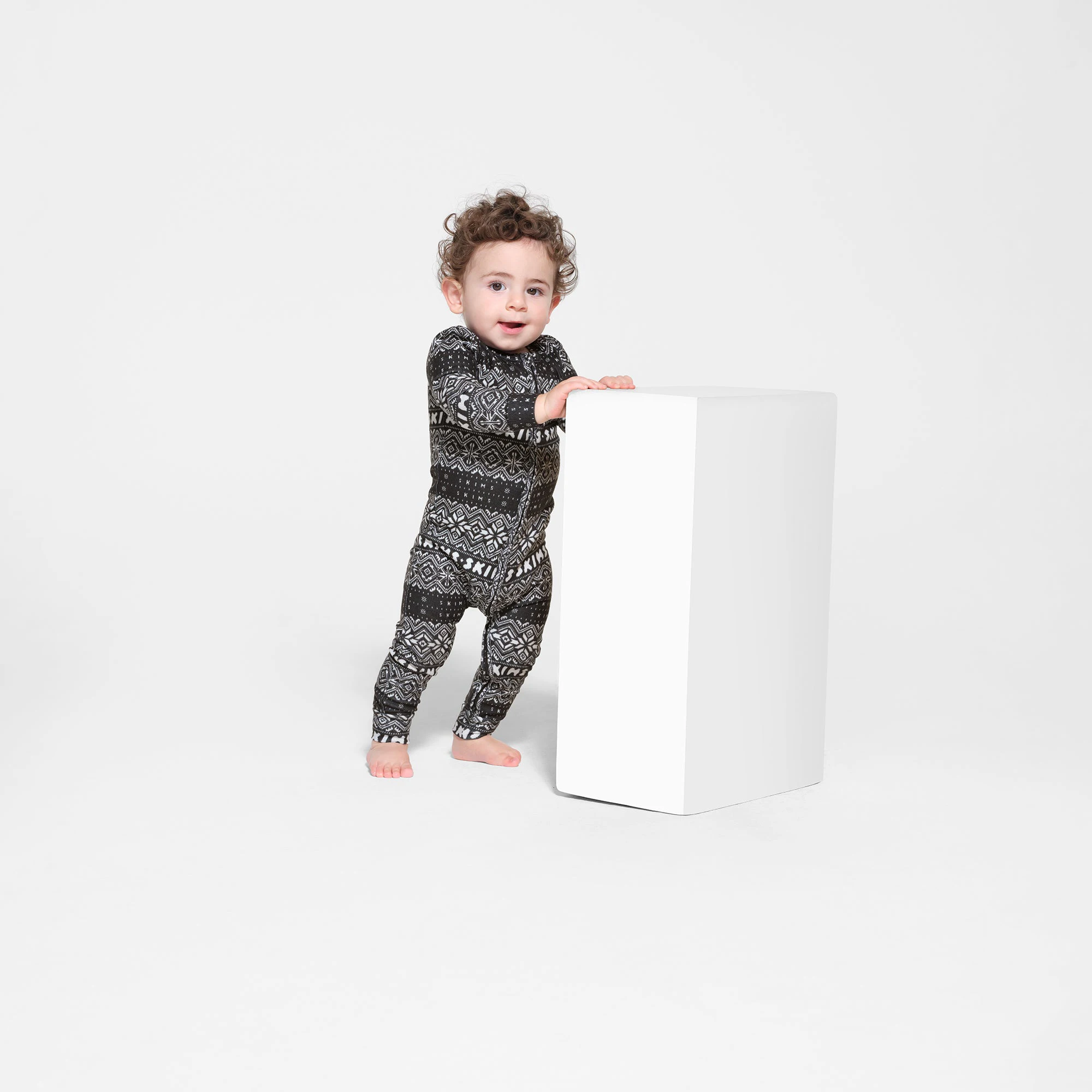 LOGO PLUSH POINTELLE BABY ONESIE | ONYX FAIR ISLE ON A MODEL FRONT VIEW