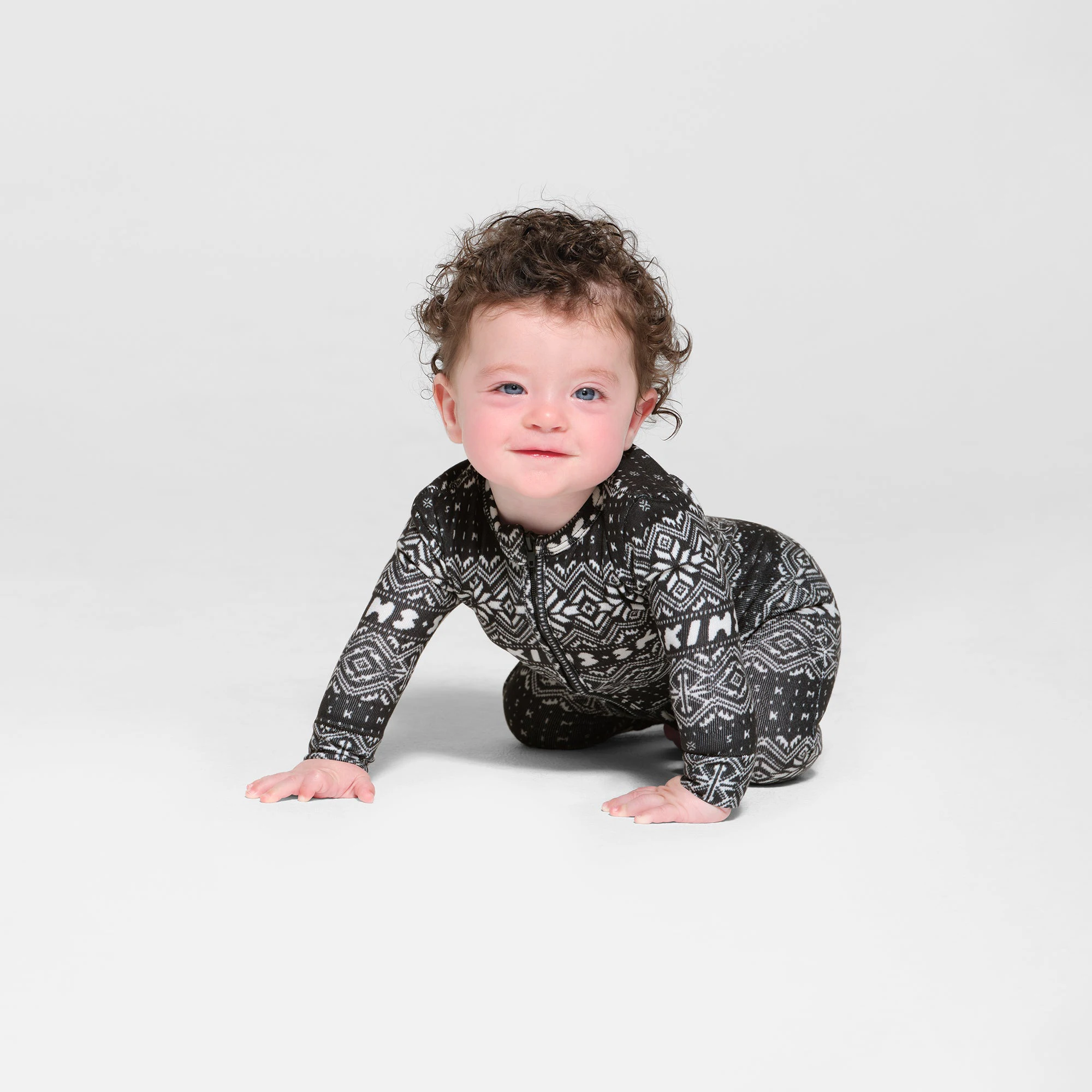 LOGO PLUSH POINTELLE BABY ONESIE | ONYX FAIR ISLE ON A MODEL SIDE VIEW
