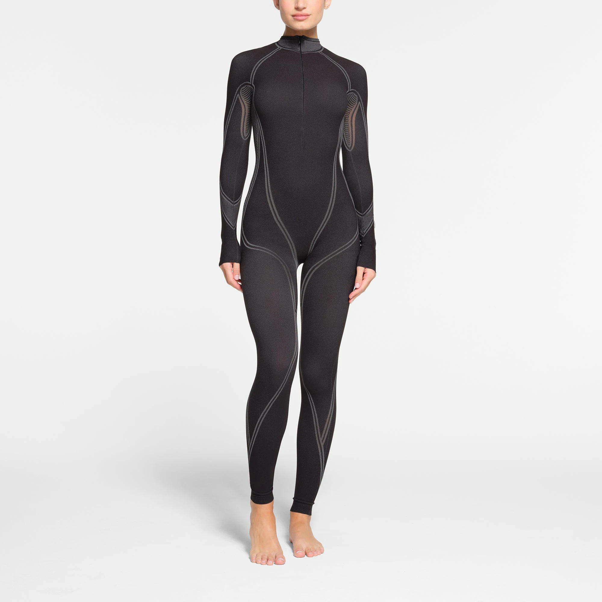SKIMS FIRST LAYERS ZIP FRONT CATSUIT | ONYX ON A MODEL FRONT VIEW