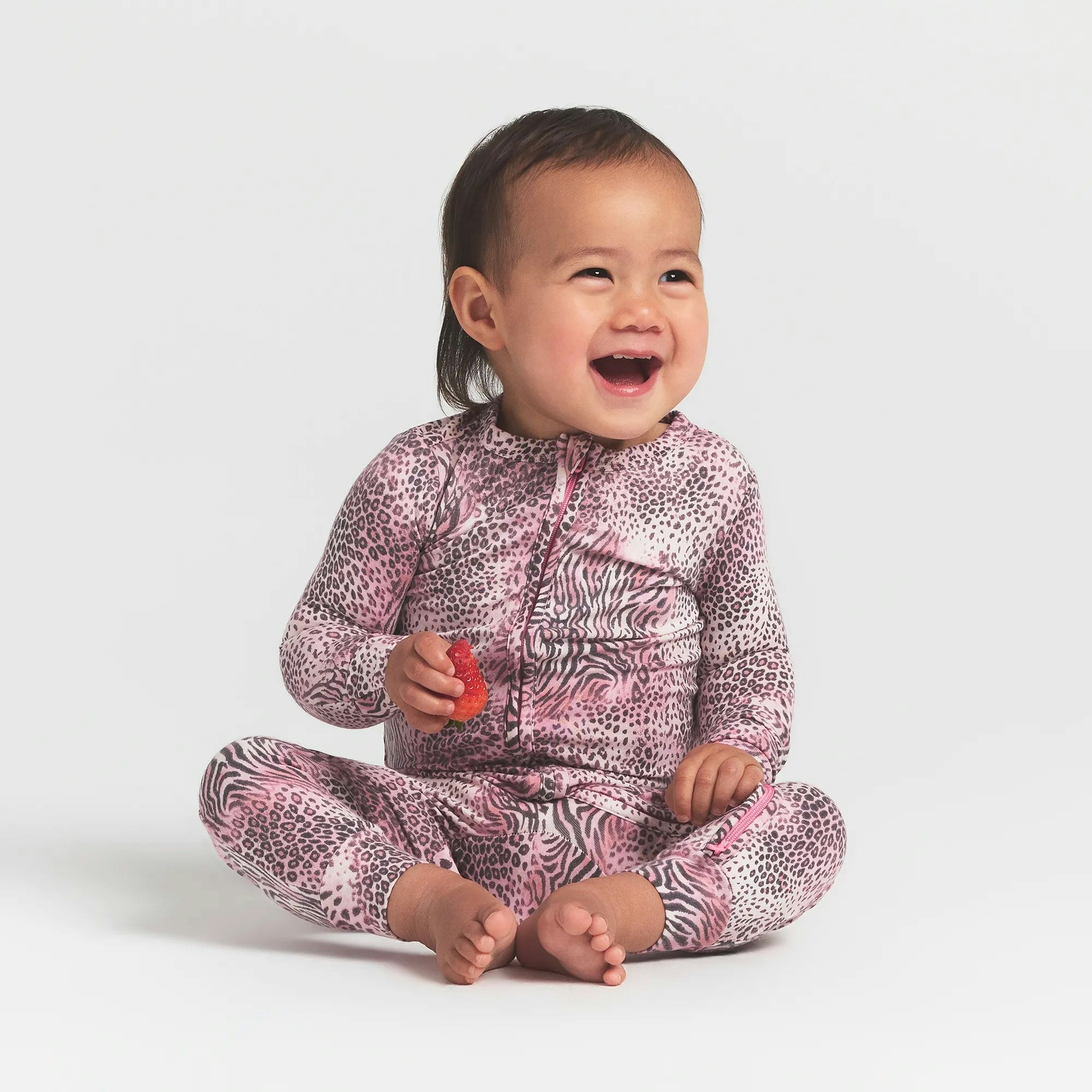 SKIMS SLEEP BABY ONESIE | BLOOM MINI MULTI ANIMAL ON A MODEL FRONT VIEW @ | FOCUS: 0.0, 1.0, 0.9