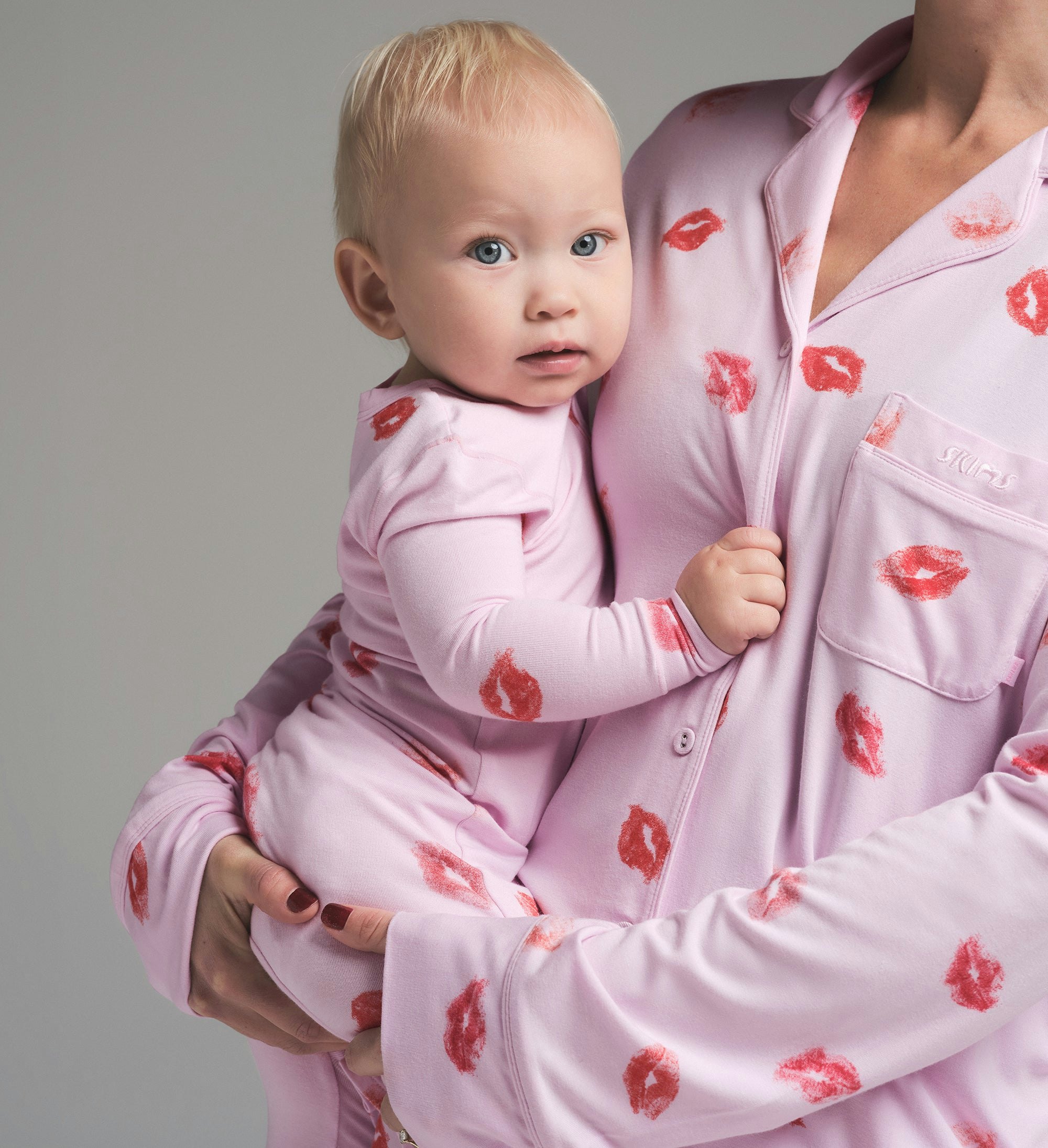 SKIMS SLEEP BABY ONESIE | CHERRY BLOSSOM LIPSTICK ON A MODEL SIDE VIEW | FOCUS: 0.0, 1.0, 0.9